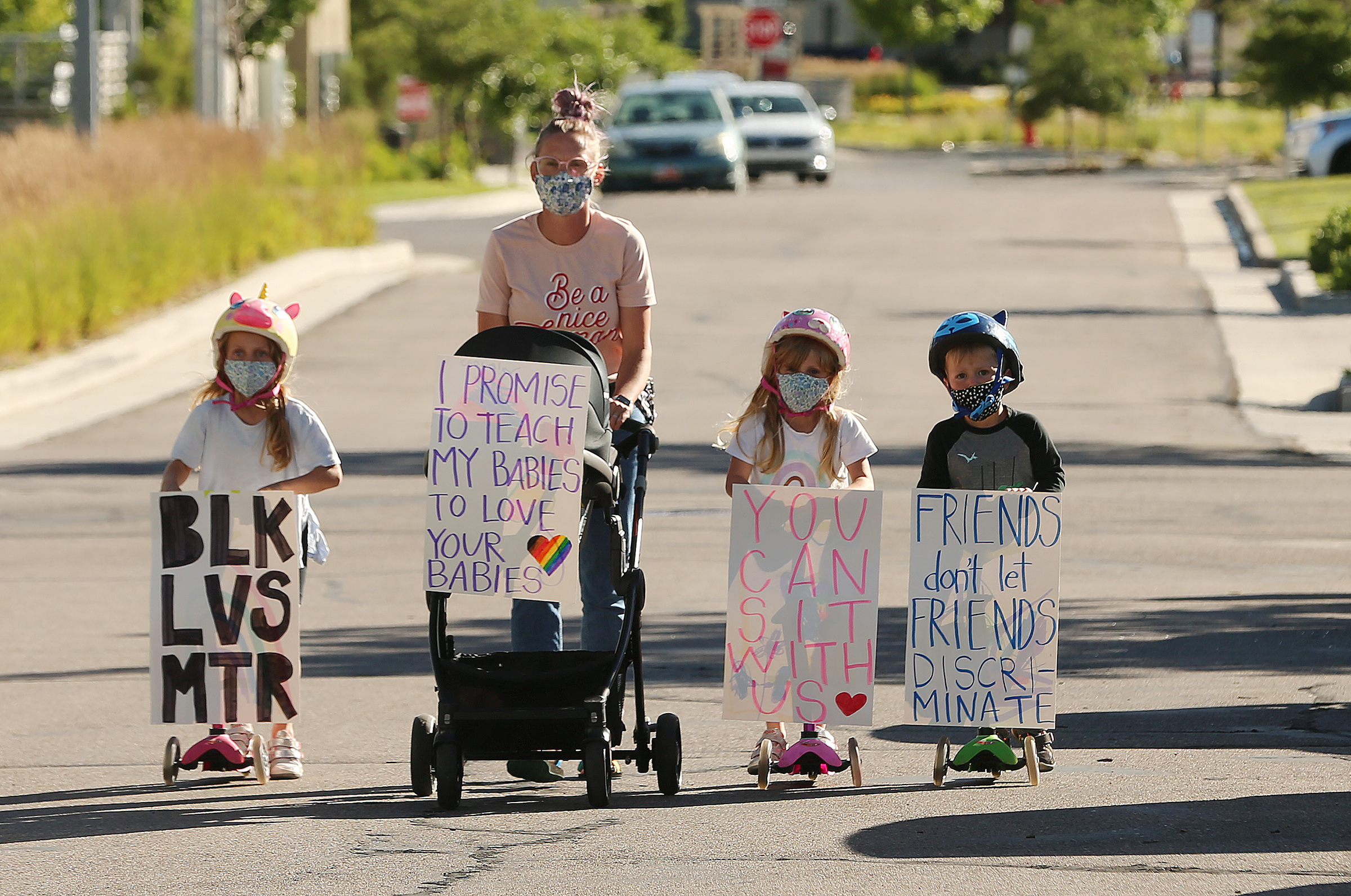 Brittany Cross walks down the street with her kids Georgia, Eli, Lucy and David as they join several hundred demonstrators who gathered to march for Black Lives Matter at Daybreak in South Jordan on Wednesday, June 17, 2020. (Scott G. Winterton, KSL)