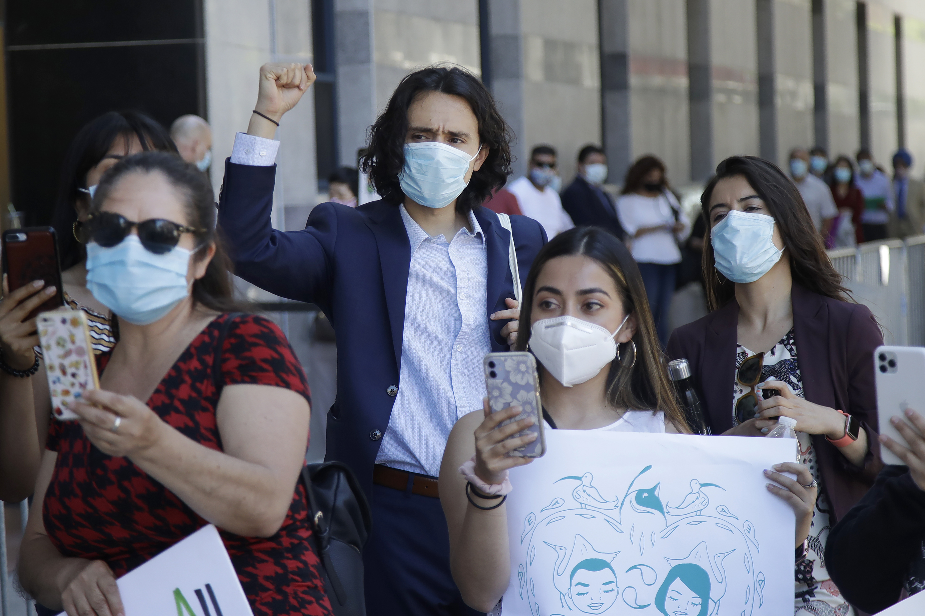 Luis Angel Reyes Savalza, center, raises his fist as he listens to speakers at a rally of immigrant youths and supporters in San Francisco, Thursday, June 18, 2020. (Photo: Jeff Chiu, AP Photo)