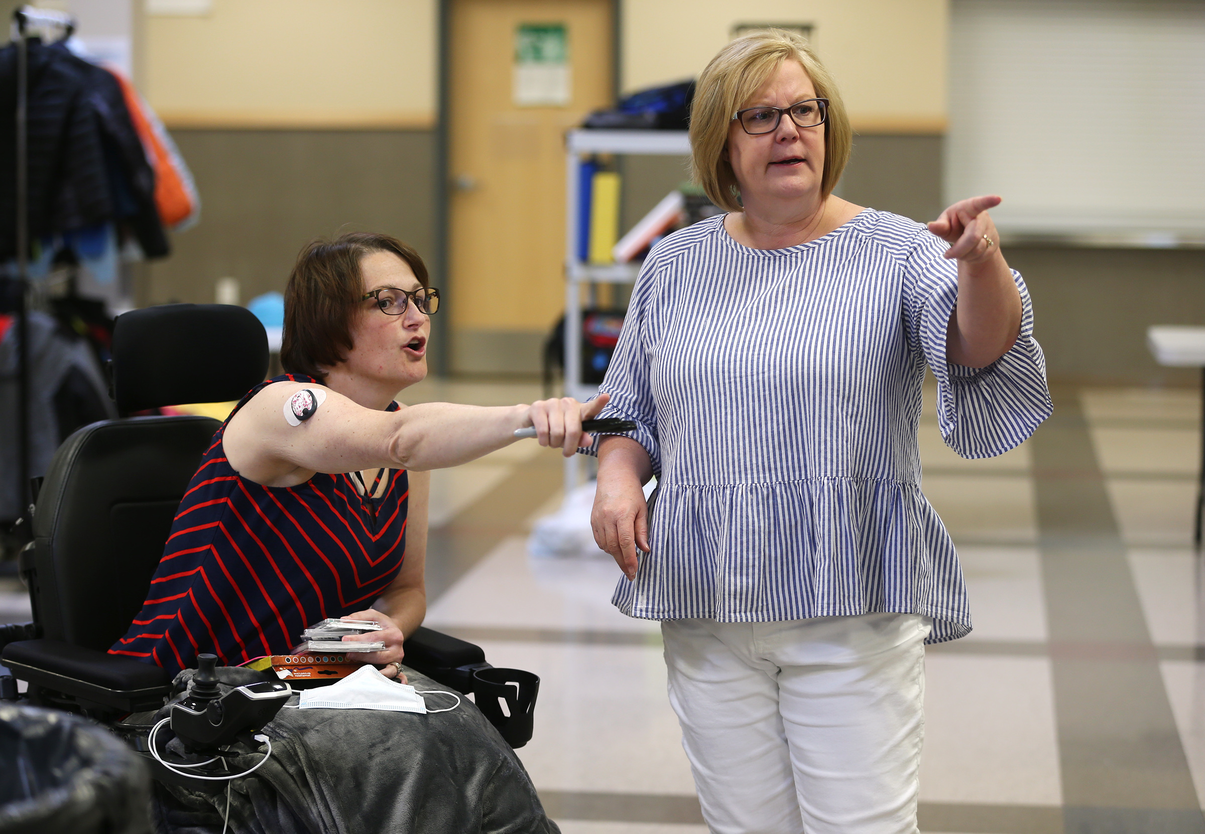Ravien Parsons and Principal Diana Brantley talk about placement of items as they work to organize yard sale items at Summit Academy in Bluffdale on Friday, June 19, 2020. Parsons has experienced a sudden disability after being diagnosed with stiff-person syndrome. The charter school where she teaches is holding the fundraiser to help her buy a wheelchair-accessible van so she can continue to work and more effectively live her life. (Scott G Winterton, KSL)