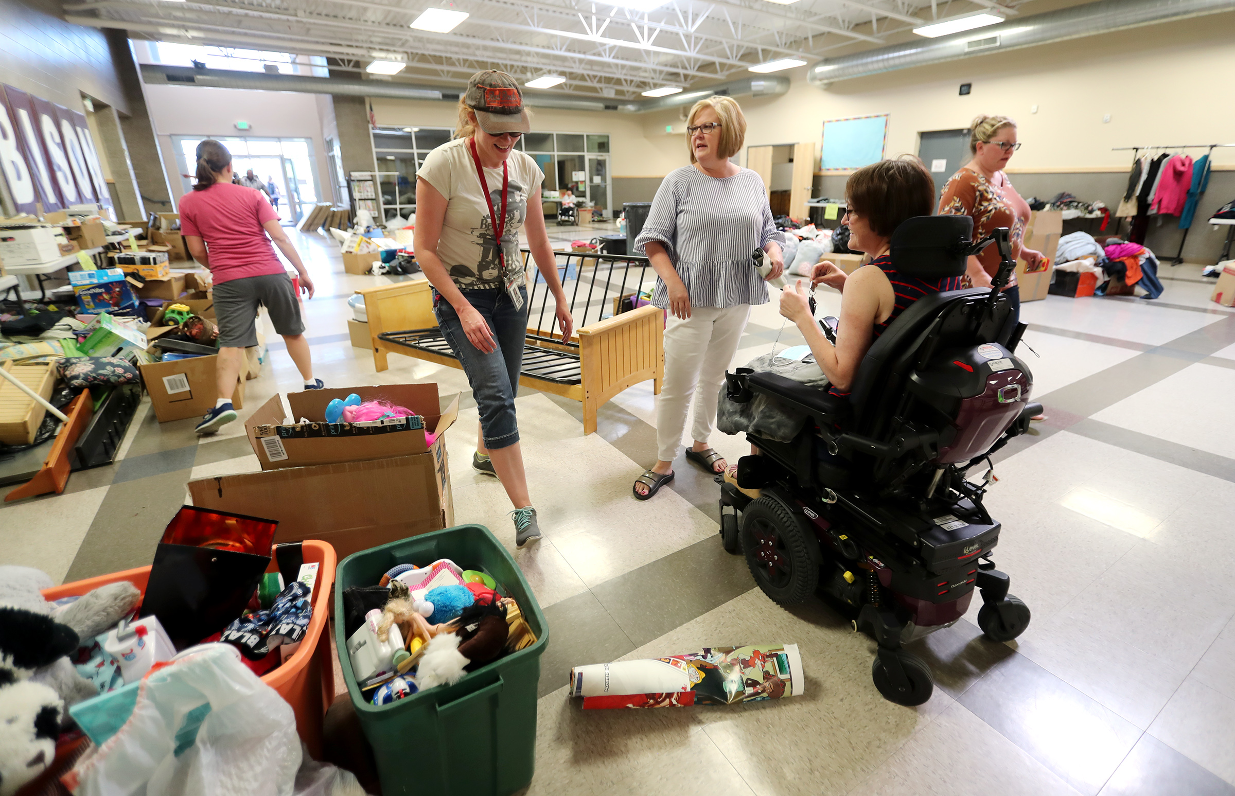 Vice Principal Rebecca Howland and Principal Diana Brantley talk with teacher Ravien Parsons as they organize yard sale items at Summit Academy in Bluffdale on Friday, June 19, 2020. Parsons has experienced a sudden disability after being diagnosed with stiff-person syndrome. The charter school where she teaches is holding the fundraiser to help her buy a wheelchair-accessible van so she can continue to work and more effectively live her life. (Scott G. Winterton, KSL)