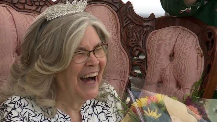 Arda Jean Christensen, complete with tiara, laughs as the Corgis go by. (SKL TV)