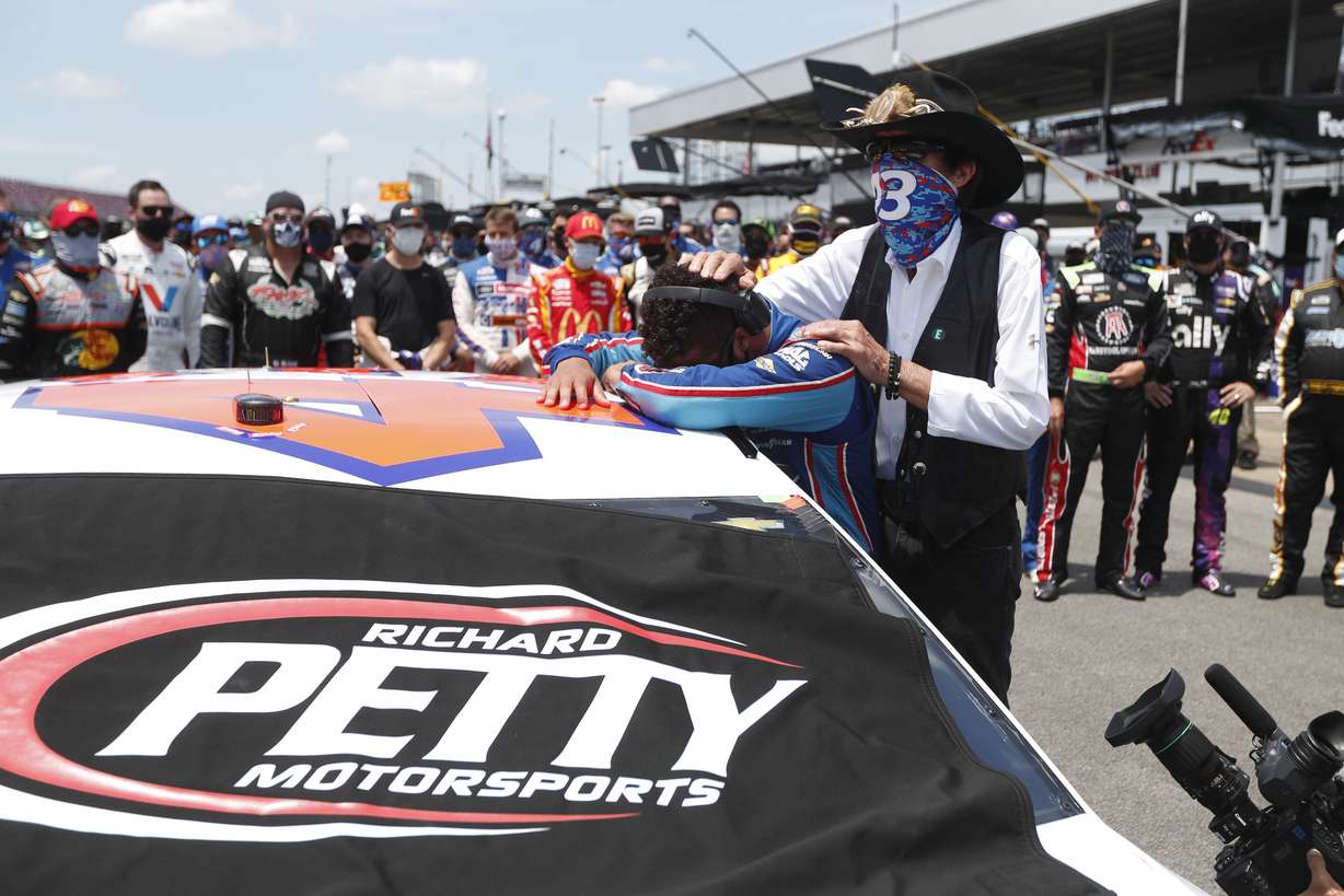 Driver Bubba Wallace, right, is overcome with emotion as he and team owner Richard Petty walk to his car in the pits of the Talladega Superspeedway prior to the start of the NASCAR Cup Series auto race at the Talladega Superspeedway in Talladega Ala., Monday June 22, 2020. (John Bazemore, AP Photo)