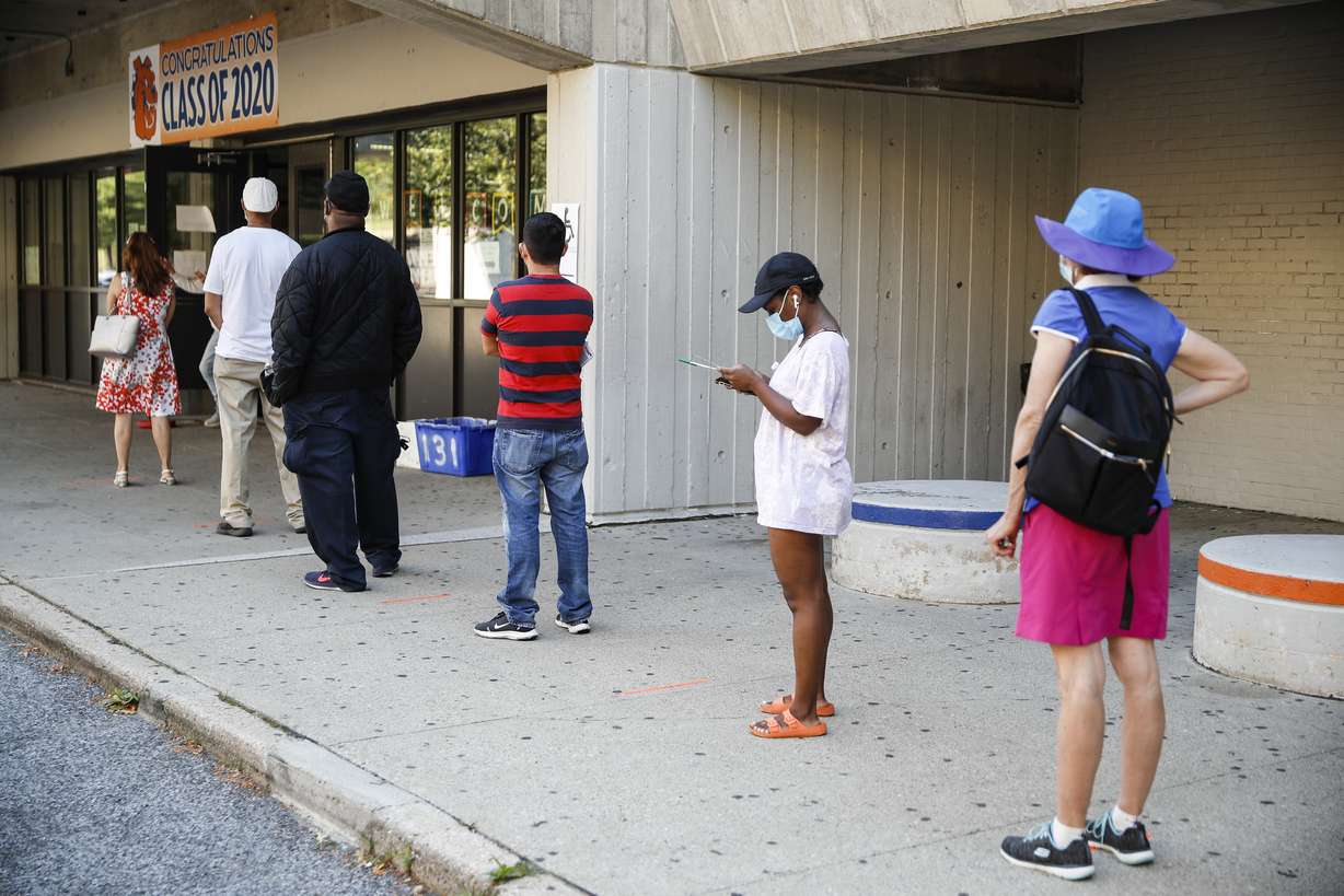 Voters wait in line to cast their ballots in New York's primary election at a polling station inside Yonkers Middle/High School, Tuesday, June 23, 2020, in Yonkers, N.Y. (John Minchillo, AP Photo)