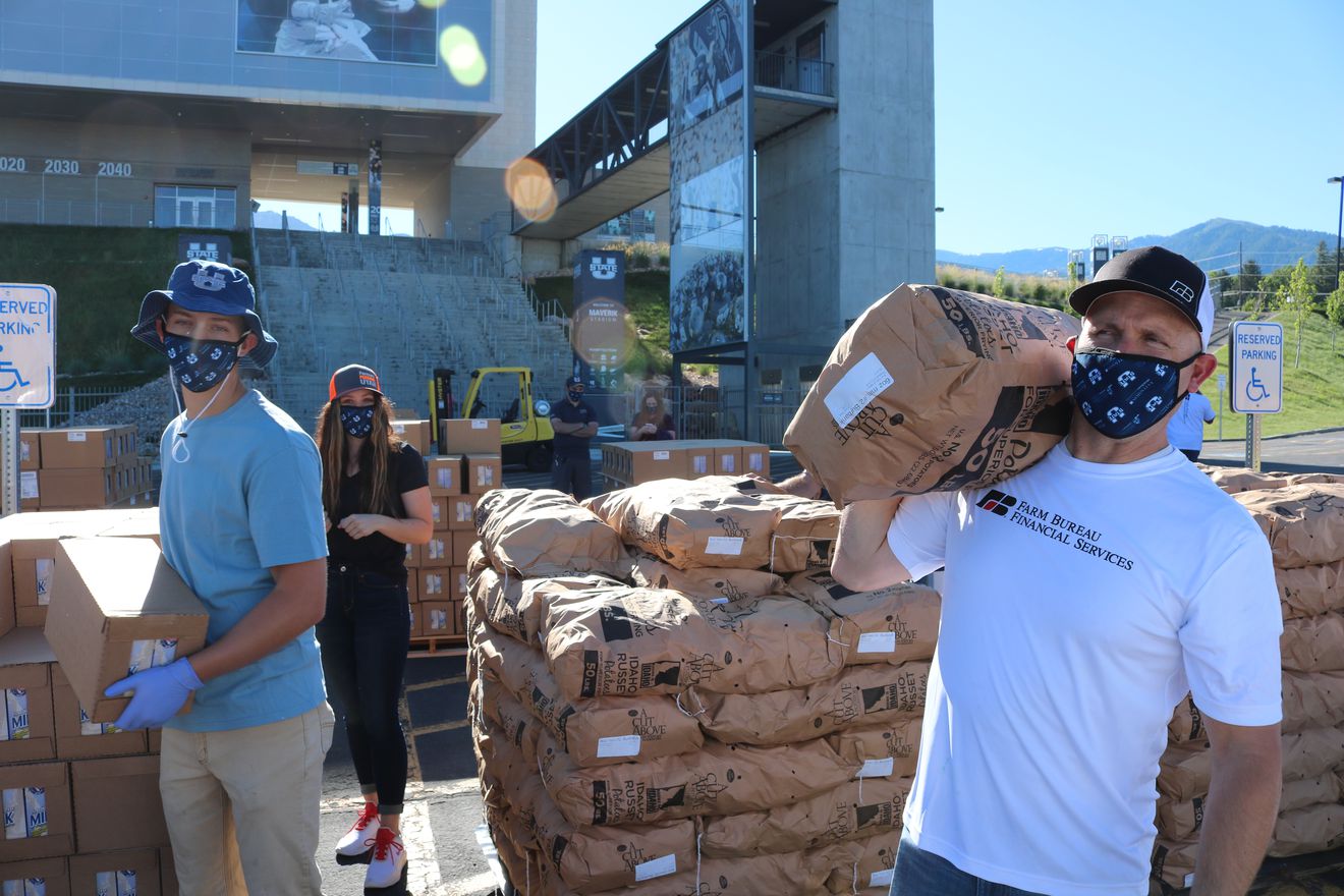 Volunteers carry 50-pound bags of potatoes to waiting cars as part of Tuesday’s Farmers Feeding Utah event in Cache Valley. (Photo: Matt Hargreaves, Utah Farm Bureau)