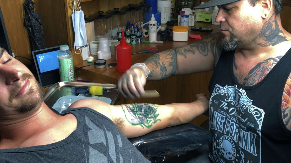 Tattoo artist sees bump in desire to erase hateful skin art