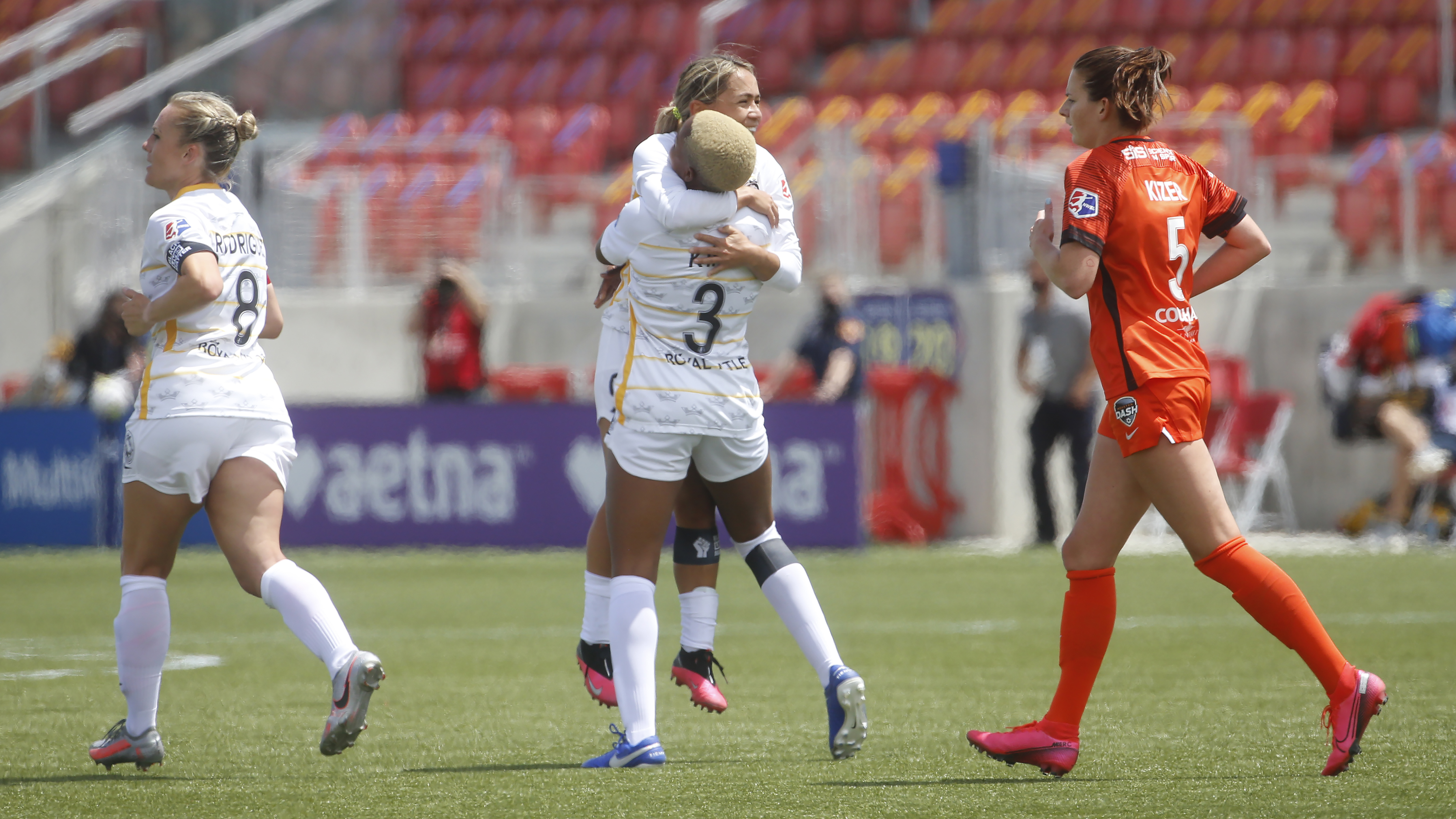 Utah Royals FC forward Tziarra King (3) receives a hug from teammate Lo'eau LaBonta after scoring against the Houston Dash during the second half of an NWSL Challenge Cup soccer match at Zions Bank Stadium Tuesday, June 30, 2020, in Herriman, Utah. (AP Photo/Rick Bowmer)
