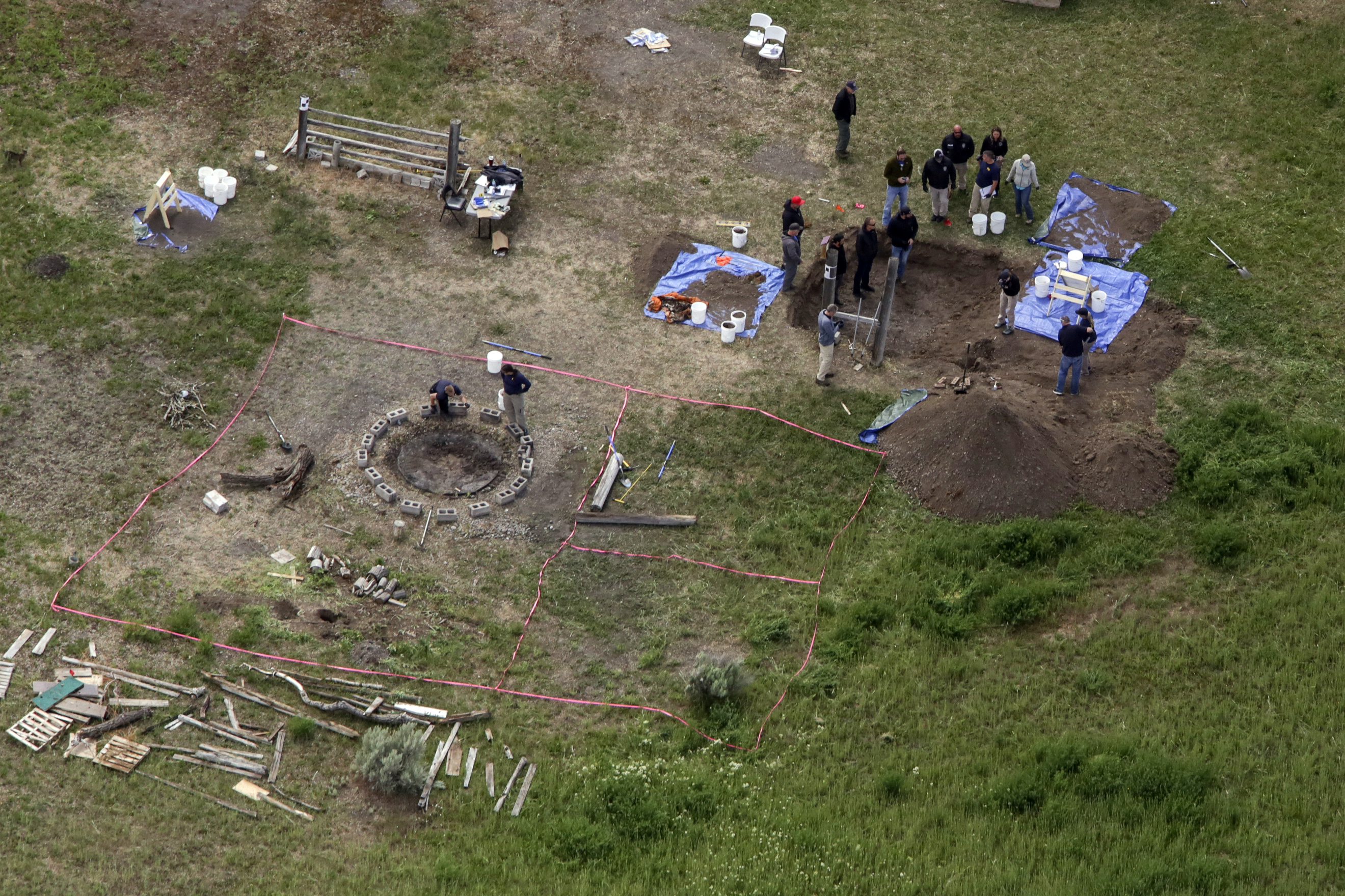 FILE - In this Tuesday, June 9, 2020, file aerial photo, investigators search for human remains at Chad Daybell's residence in the 200 block of 1900 east, in Salem, Idaho. Court documents say authorities used cellphone information from the now-deceased uncle of two missing Idaho children to find the youths' bodies on Daybell's rural property. Daybell and the children's mother, Lori Vallow Daybell, are in custody. (John Roark/The Idaho Post-Register via AP, File)