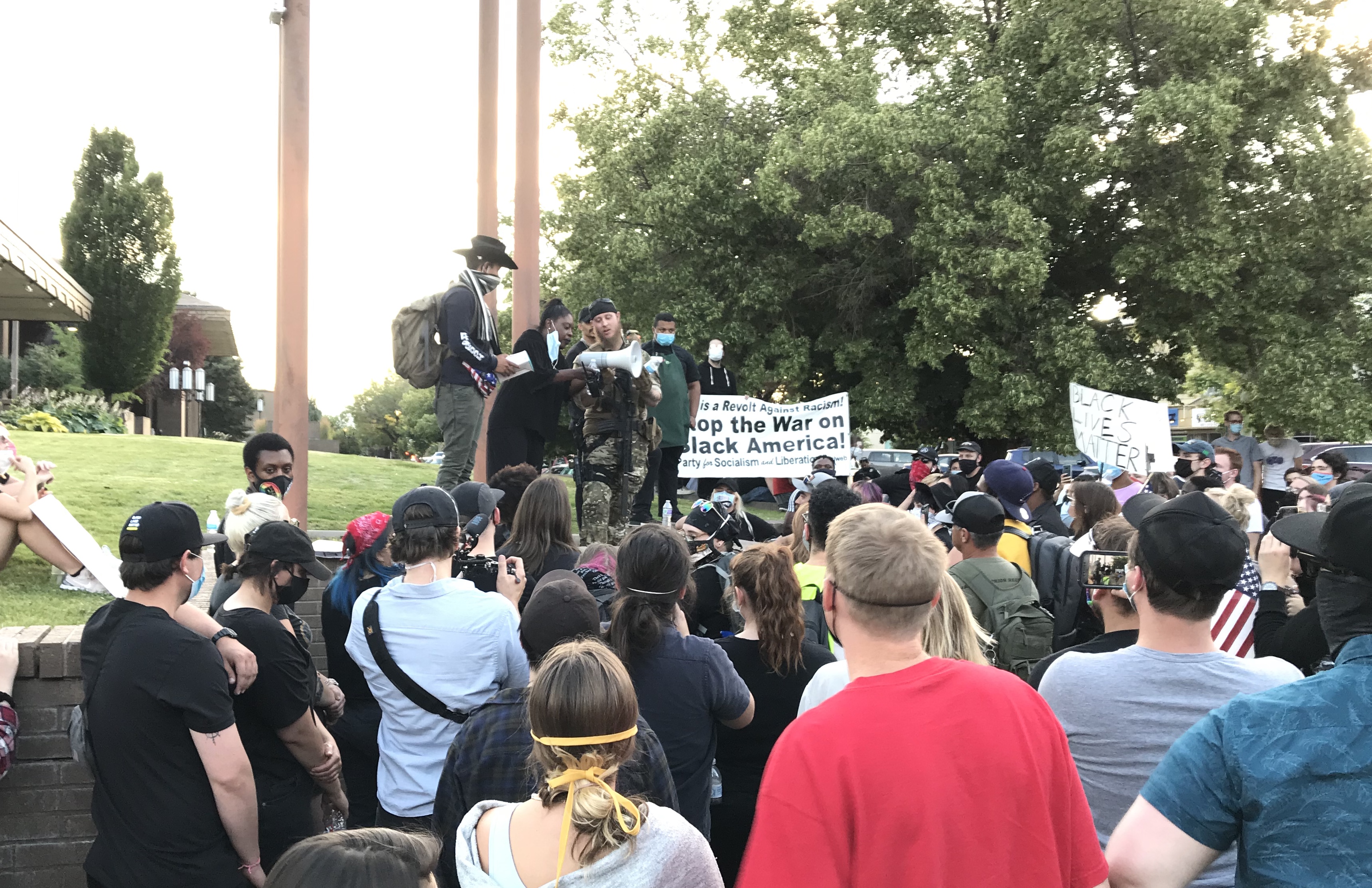 James Fitzpatrick of the militia group Keepers of Liberty, middle, prepares to address protesters calling for racial equality after being helped up on the retaining wall in front of the Provo police station in downtown Provo, Wednesday, July 1, 2020. (Photo: Photo: Sean Walker, KSL.com)