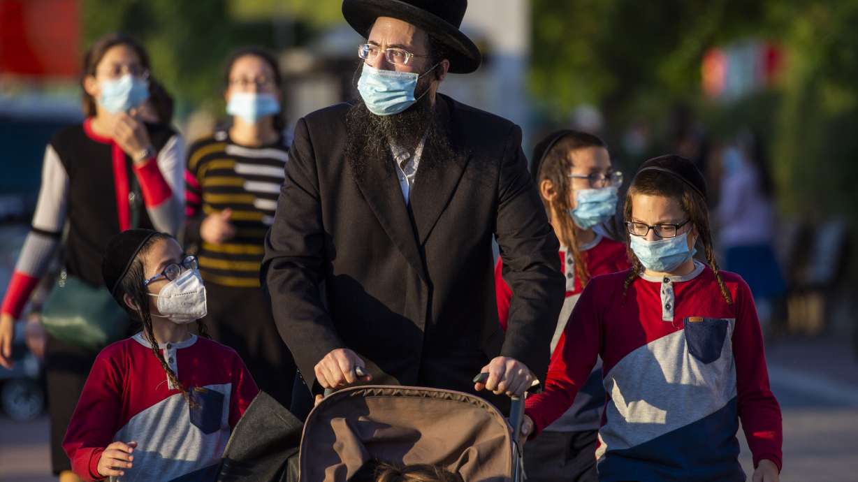 Israel, Palestinians face new restrictions amid virus surge