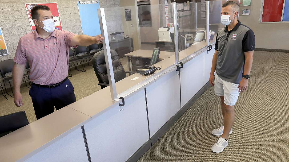 Granger High School Principal David Dunn and assistant principal David Beck show plexiglass walls that were recently installed at the West Valley school on Thursday, July 9, 2020. The plexiglass was installed to help prevent the spread of COVID-19.