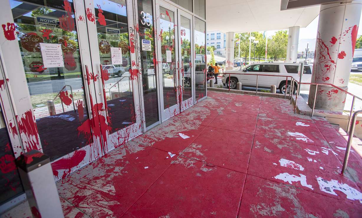 The front walk and other areas of the Salt Lake County District Attorney’s Office building in Salt Lake City is covered in red paint on Friday, July 10, 2020. The building suffered tens of thousands of dollars in damage when protesters broke out at least three windows and spread red paint over large portions of the building and area in front of the structure on Thursday.