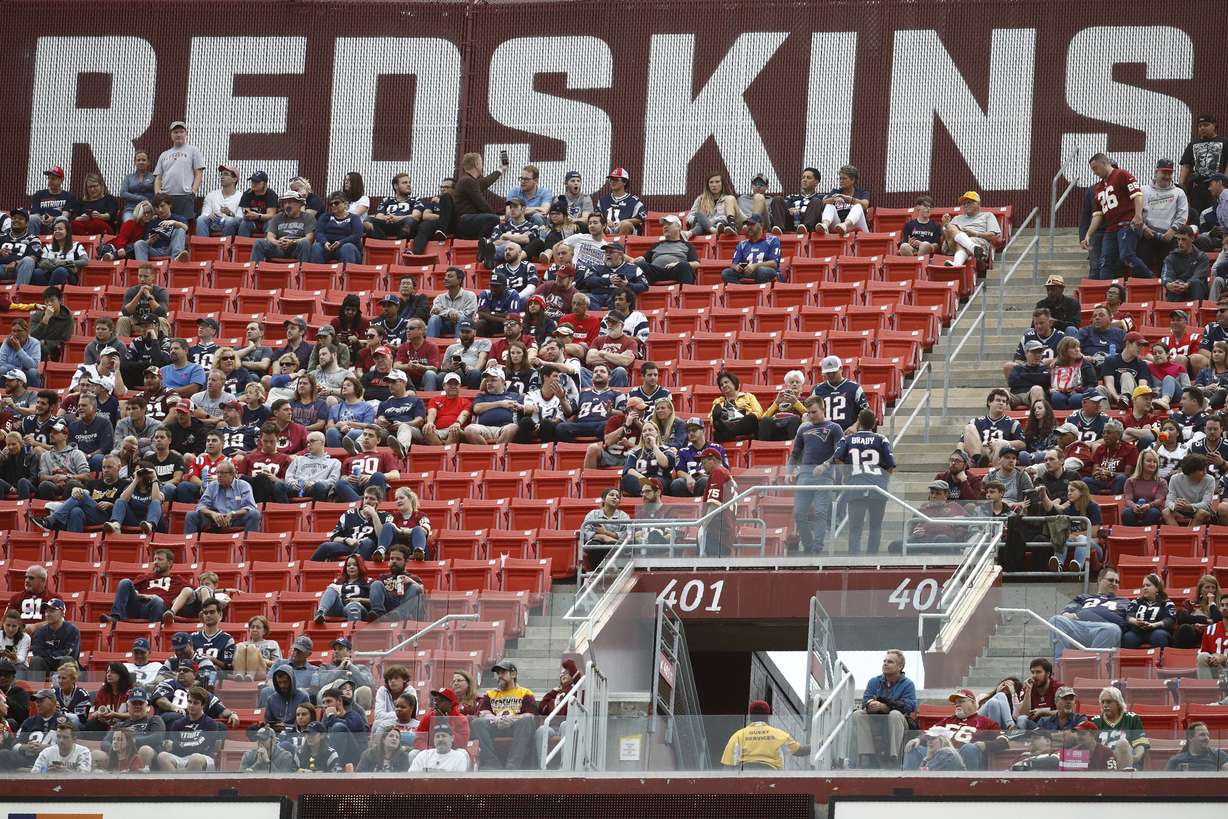 FILE - In this Oct. 6, 2019, file photo, fans watch play between the Washington Redskins and the New England Patriots during the second half of an NFL football game, in Landover, Md. (AP Photo/Patrick Semansky, File)