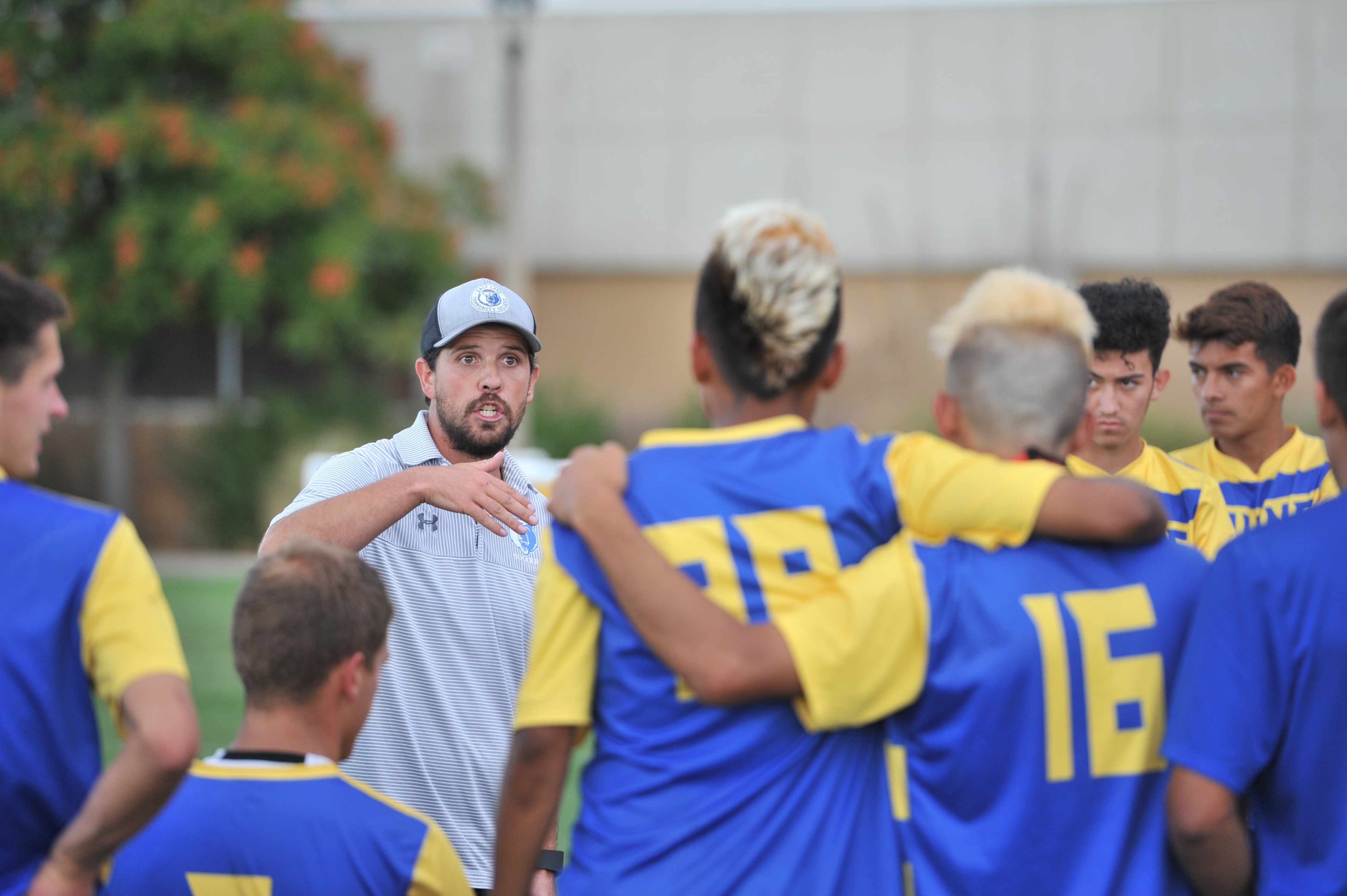 Salt Lake CC head coach Mark Davis makes halftime adjustments during a match against College of Southern Nevada.
