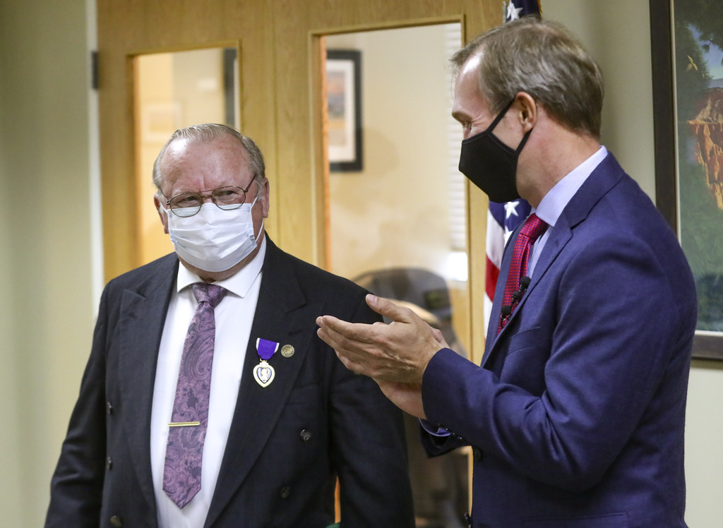 Douglas W. Evans smiles from under his mask after being presented the Purple Heart by Utah Rep. Ben McAdams, D-Utah, at McAdams' office in West Jordan on Monday, July 13, 2020. Evans received the award for wounds suffered during the Vietnam War. McAdams’ staff worked with the Department of Defense on behalf of the Evans family to untangle a paperwork issue that for 50 years prevented the medal citation from being included in his official Army record.