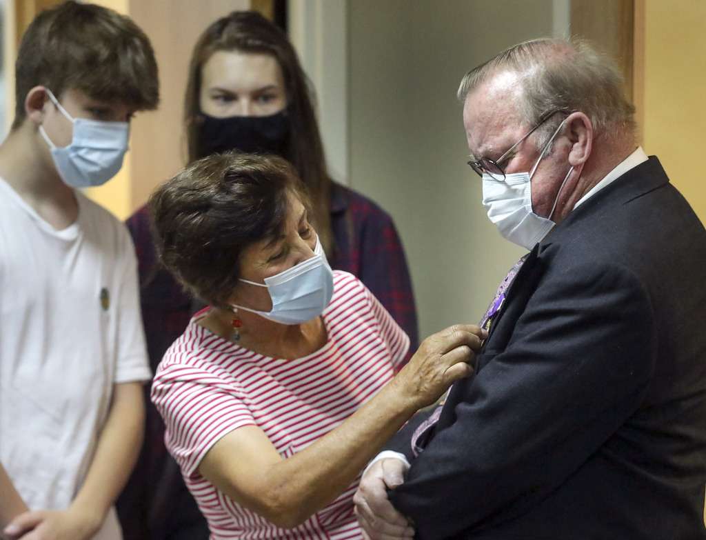 Fanny Douglas gets a closer look at the Purple Heart award her husband, Douglas W. Evans, was presented by Utah Rep. Ben McAdams, D-Utah, at McAdams' office on Monday, July 13, 2020. Evans received the award for wounds suffered during the Vietnam War. McAdams’ staff worked with the Department of Defense on behalf of the Evans family to untangle a paperwork issue that for 50 years prevented the medal citation from being included in his official Army record.