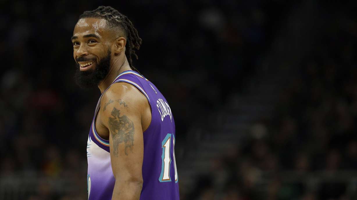 Utah Jazz's Mike Conley smiles during the first half of an NBA basketball game against the Milwaukee Bucks Monday, Nov. 25, 2019, in Milwaukee. (AP Photo/Aaron Gash)