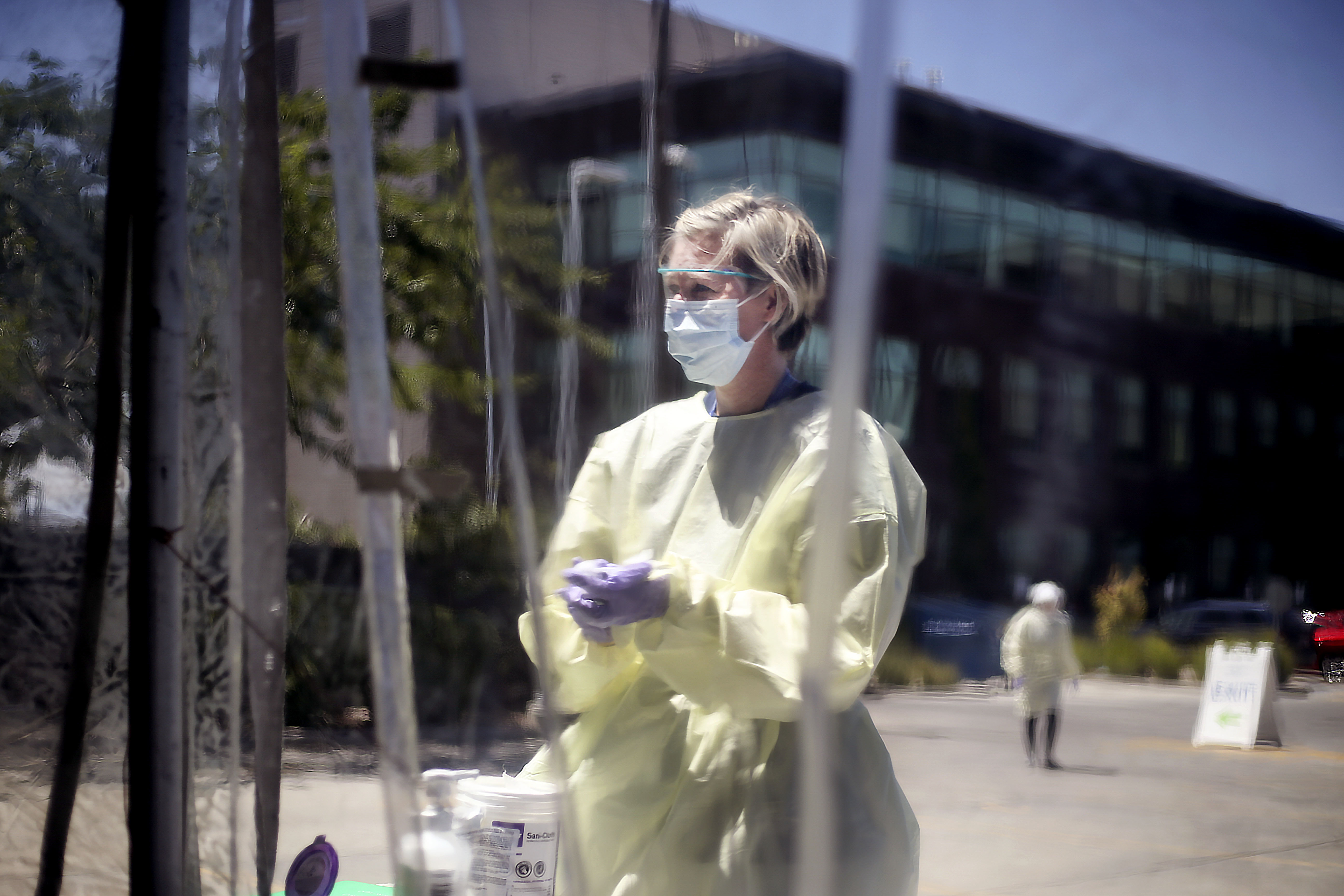 Registered nurse Beth Ann Friel sanitizes her hands at a COVD-19 test center at Intermountain Healthcare's Salt Lake Clinic on Friday, July 10, 2020. Officials from Intermountain Healthcare, University of Utah Health, MountainStar Healthcare and Steward Health Care fear that if COVID-19 cases continue to spike, they will no longer be able to effectively manage all the patients.