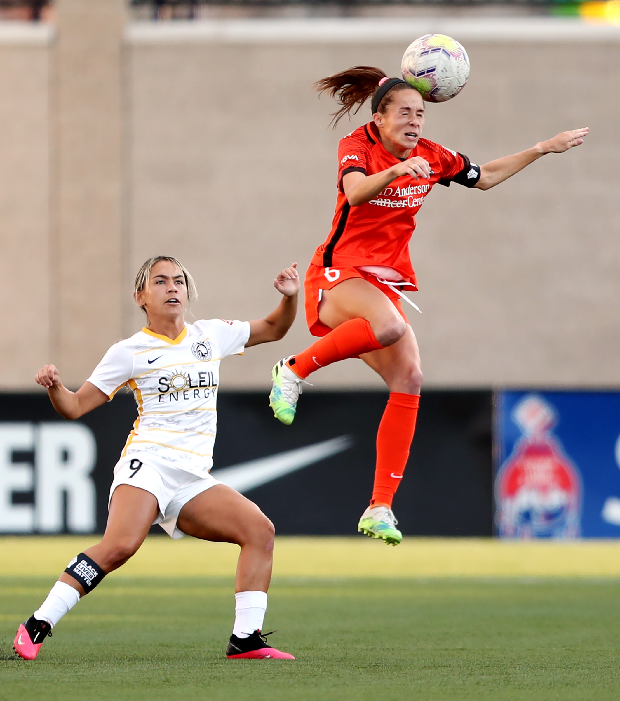 Houston Dash forward Shea Groom (6) heads the ball over Utah Royals FC midfielder Lo'eau LaBonta (9) as the Utah Royals and the Houston Dash play in the Challenge Cup quarterfinals at Zions Bank Stadium in Herriman Utah on Friday, July 17, 2020.