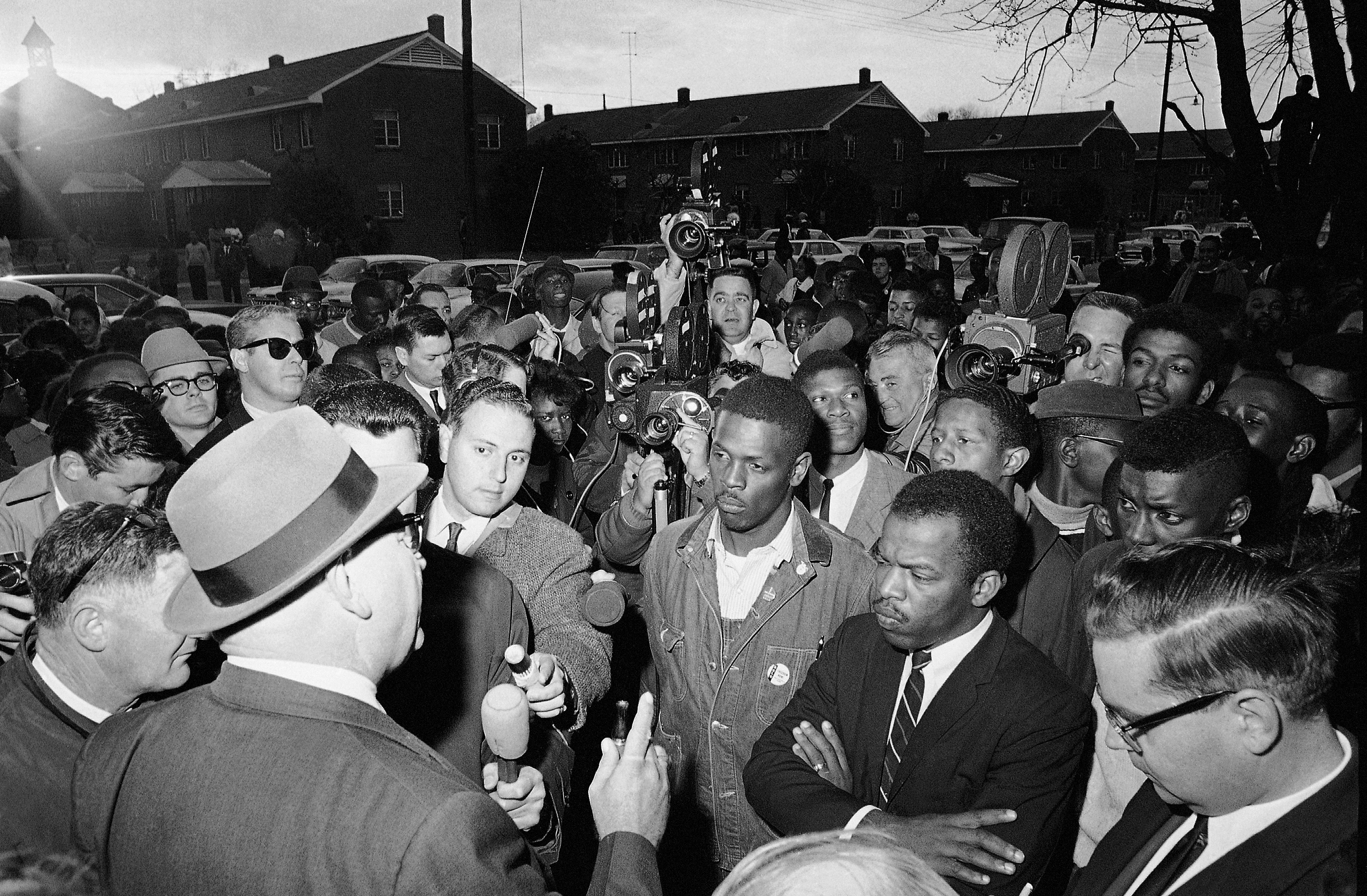 In this Feb. 23, 1965, file photo, Wilson Baker, left foreground, public safety director, warns of the dangers of night demonstrations at the start of a march in Selma, Ala. Second from right foreground, is John Lewis of the Student Non-Violent Committee. Lewis, who carried the struggle against racial discrimination from Southern battlegrounds of the 1960s to the halls of Congress, died Friday, July 17, 2020. (AP Photo/File)