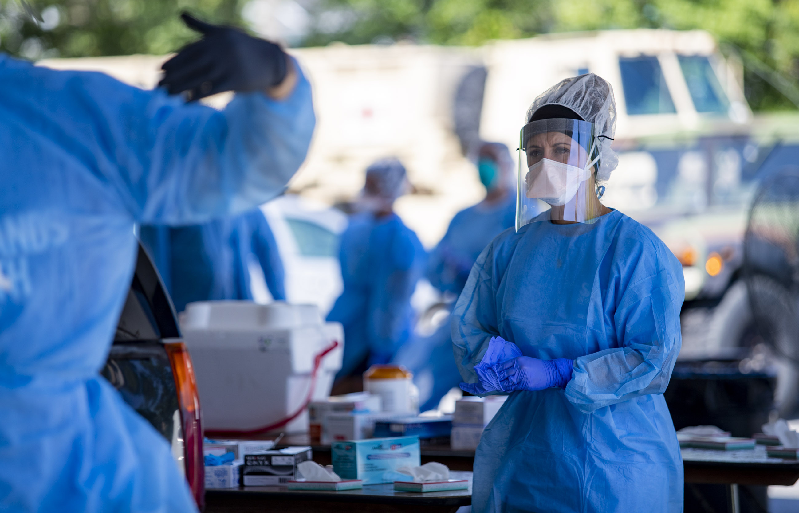 A Tidelands Health medical professional changes latex gloves during a drive-through COVID-19 testing site Friday July 17, 2020 at Myrtle Beach Pelicans Ballpark in Myrtle Beach, S.C. (Photo: Josh Bell, The Sun News via AP)