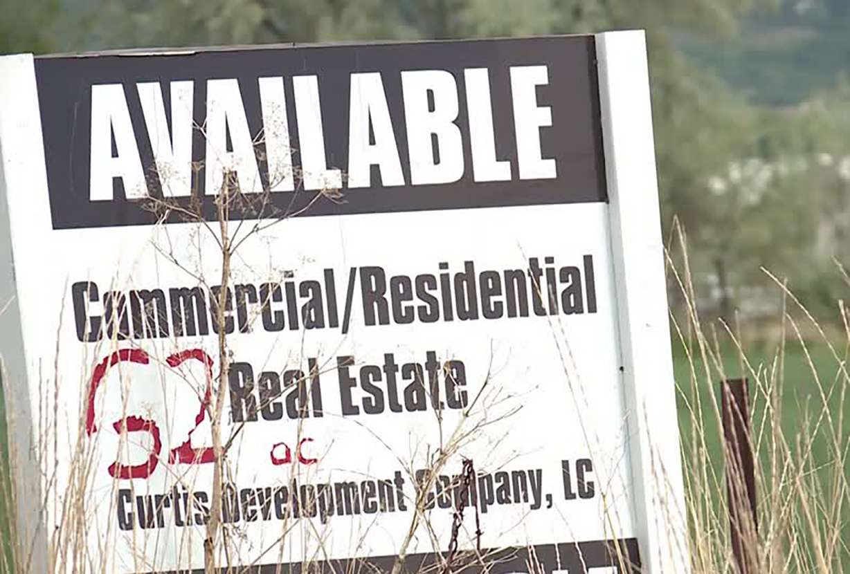 The crops with the biggest yields seem to be the signs. One reads “Available” in big block letters. Another says “For Sale, 26.95 Acres.” (Photo: Ray Boone, KSL TV)