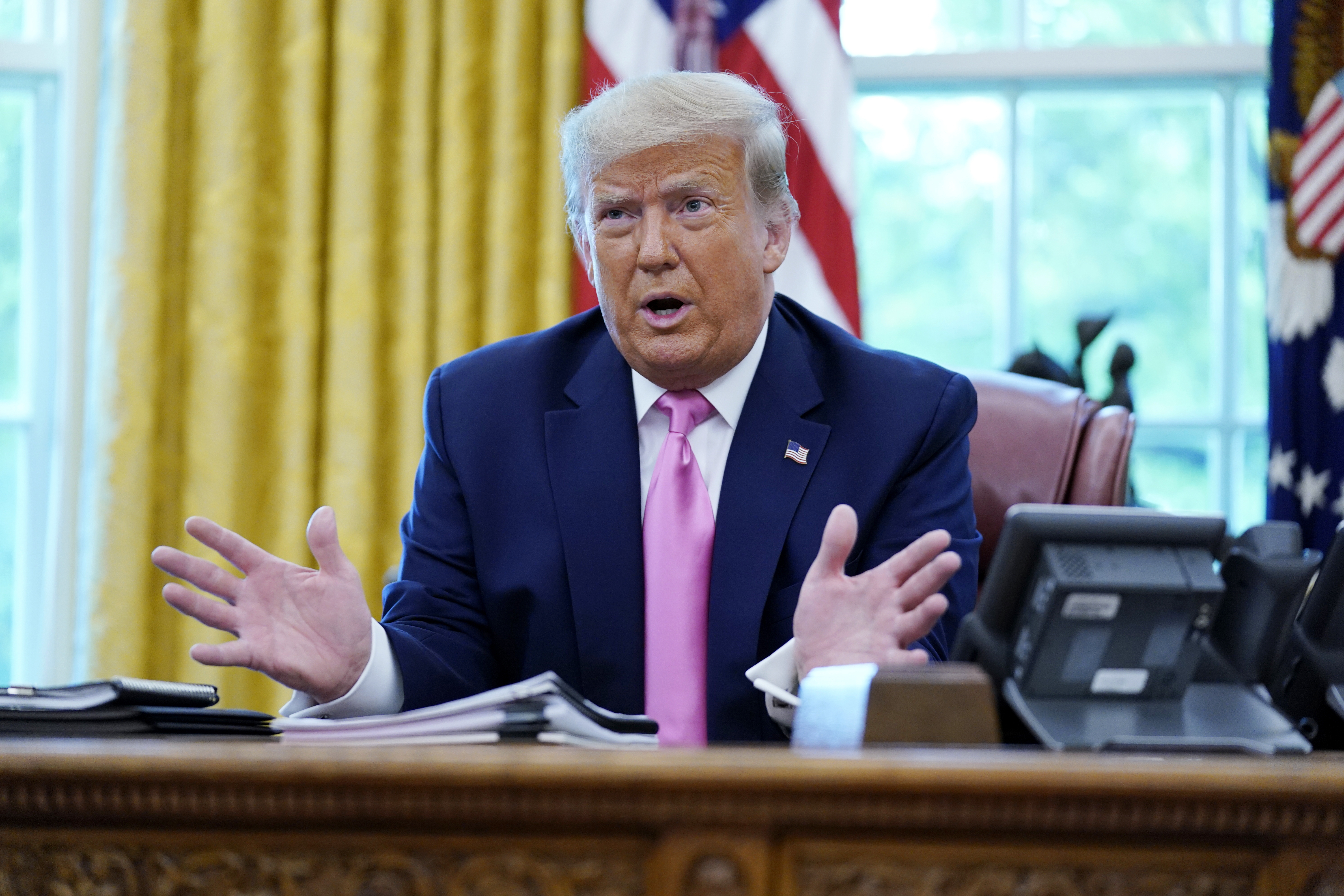 President Donald Trump speaks to the media while meeting with Senate Majority Leader Mitch McConnell and House Minority Leader Kevin McCarthy in the Oval Office at the White House, Monday, July 20, 2020, in Washington. (AP Photo/Evan Vucci)