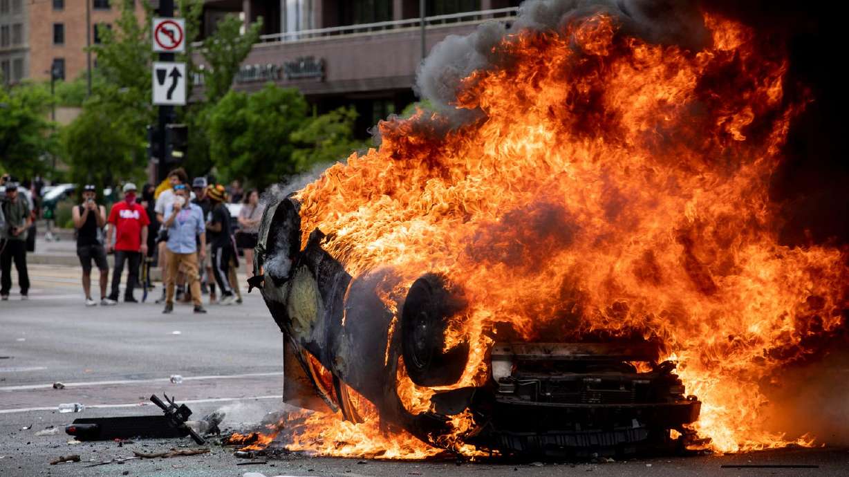 A police car is engulfed in flames as people protest police brutality in Salt Lake City on Saturday, May 30, 2020. (Photo: Ivy Ceballo, KSL, File)