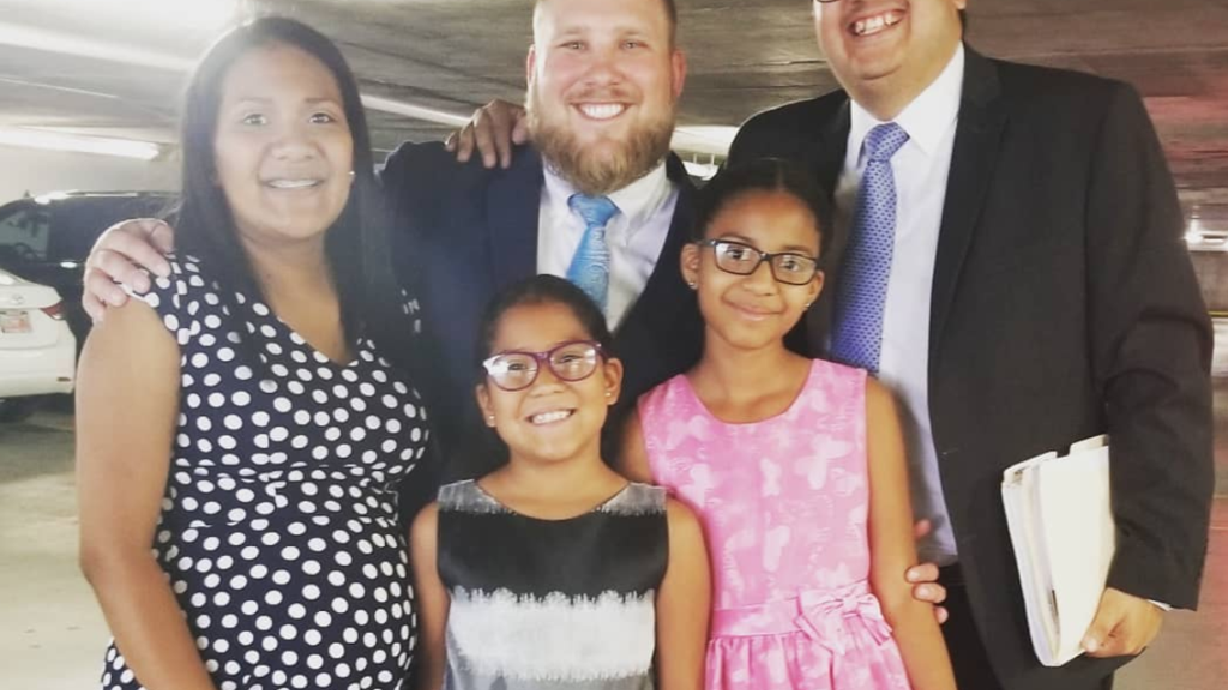 In this July 2019 photo, immigration attorney Carlos Trujillo, far right, poses with the Holt family on the day he helped secure residency status for Thamy Holt’s daughters, Marian and Nathalia. Clockwise from right: Carlos Trujillo, Marian, Nathalia, Thamy Holt and Josh Holt.