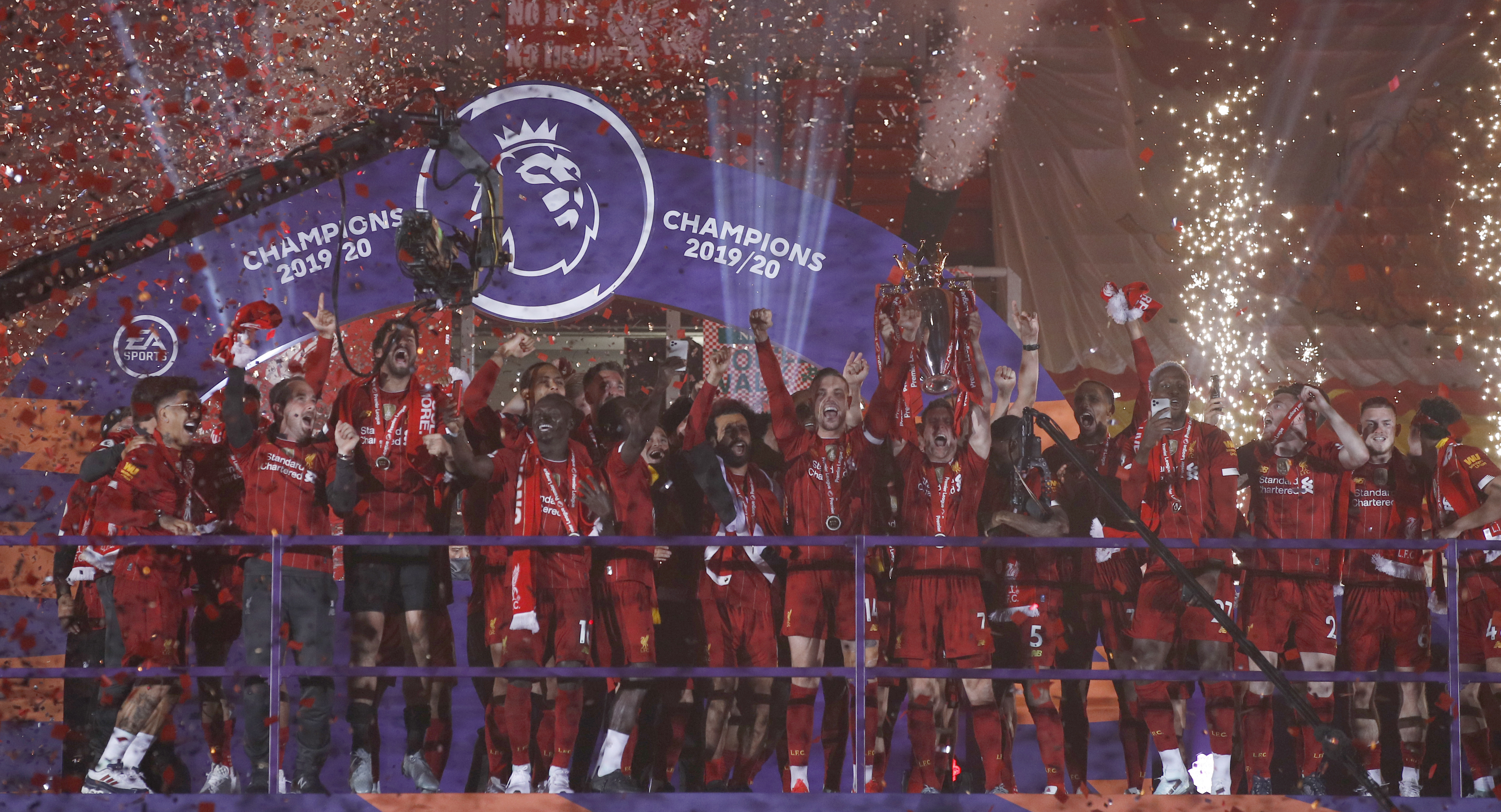 Liverpool players receive Premier League trophy on Kop 