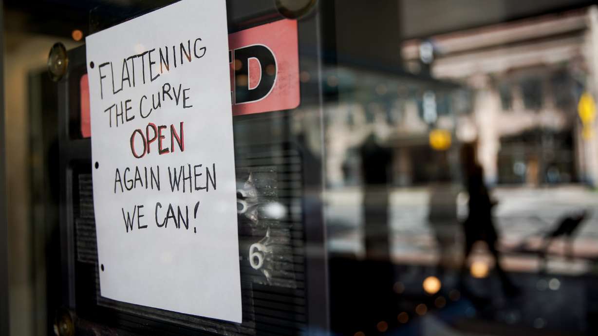 A sign in the window of The Store & Gift Shop in Ogden indicates that they are closed to prevent the spread of COVID-19 on Thursday, April 2, 2020.
