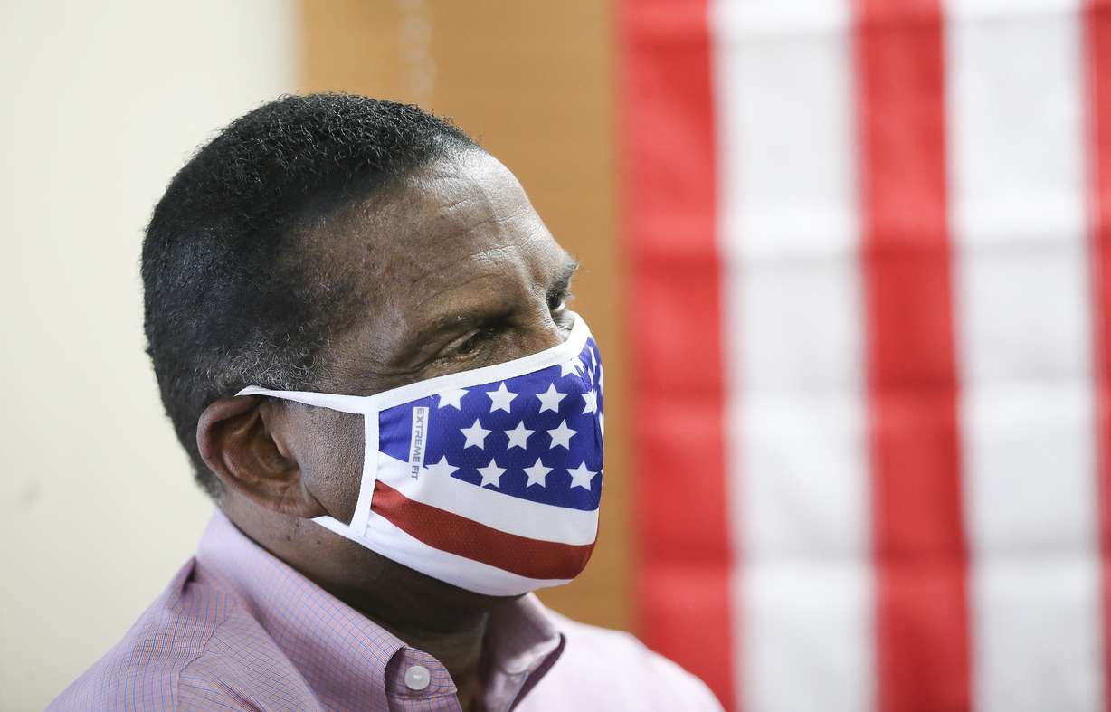 Congressional candidate Burgess Owens listens as Donald Trump Jr. speaks to volunteers at Colonial Flag in Sandy on Thursday, July 23, 2020.