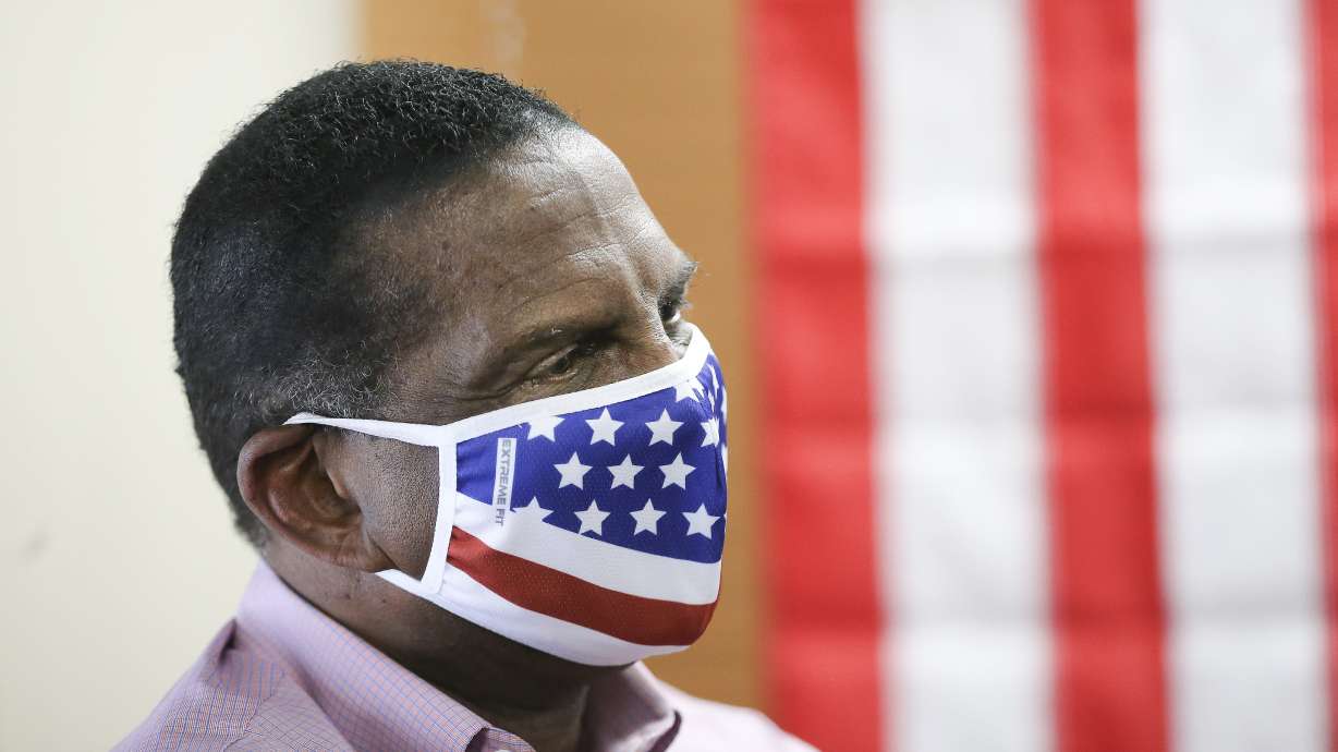 Congressional candidate Burgess Owens listens as Donald Trump Jr. speaks to volunteers at Colonial Flag in Sandy on Thursday, July 23, 2020.