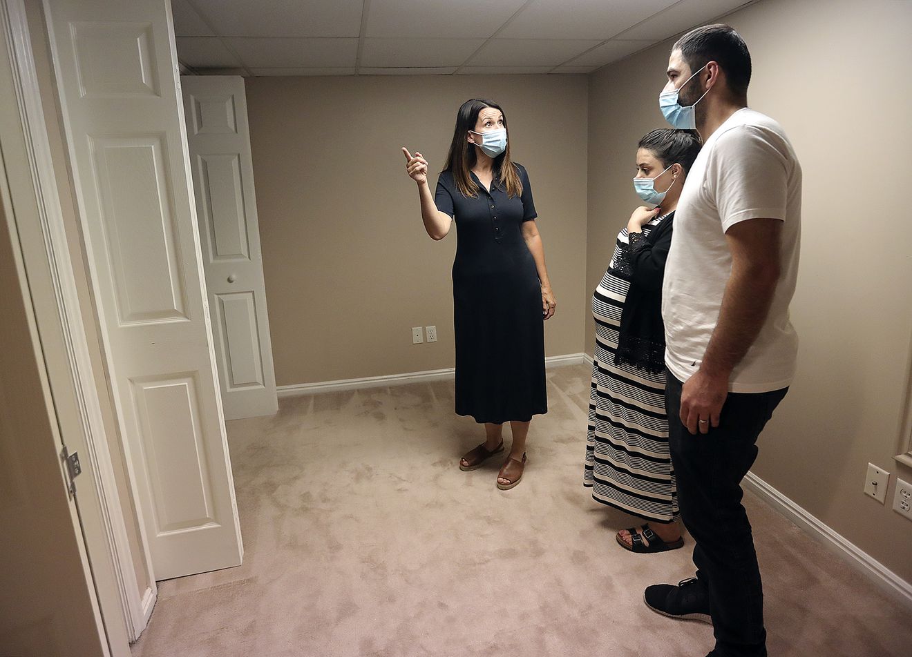 Realtor Dana Conway shows Sara Ismael and Yousif Yousif a house for sale in Sandy on Monday, July 20, 2020.