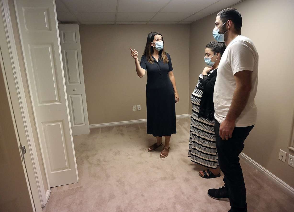 Realtor Dana Conway shows Sara Ismael and Yousif Yousif a house for sale in Sandy on Monday, July 20, 2020.