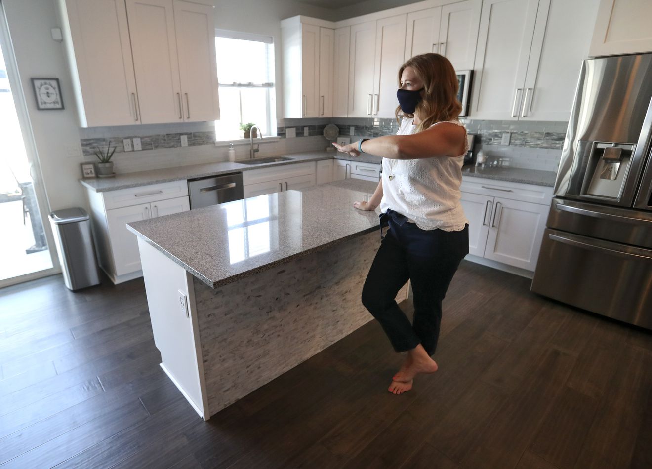 Real estate agent Alicia Holdaway, with Summit Sotheby’s International Realty and president of the Salt Lake Board of Realtors, walks through a home for sale in Bluffdale on Monday, July 20, 2020.