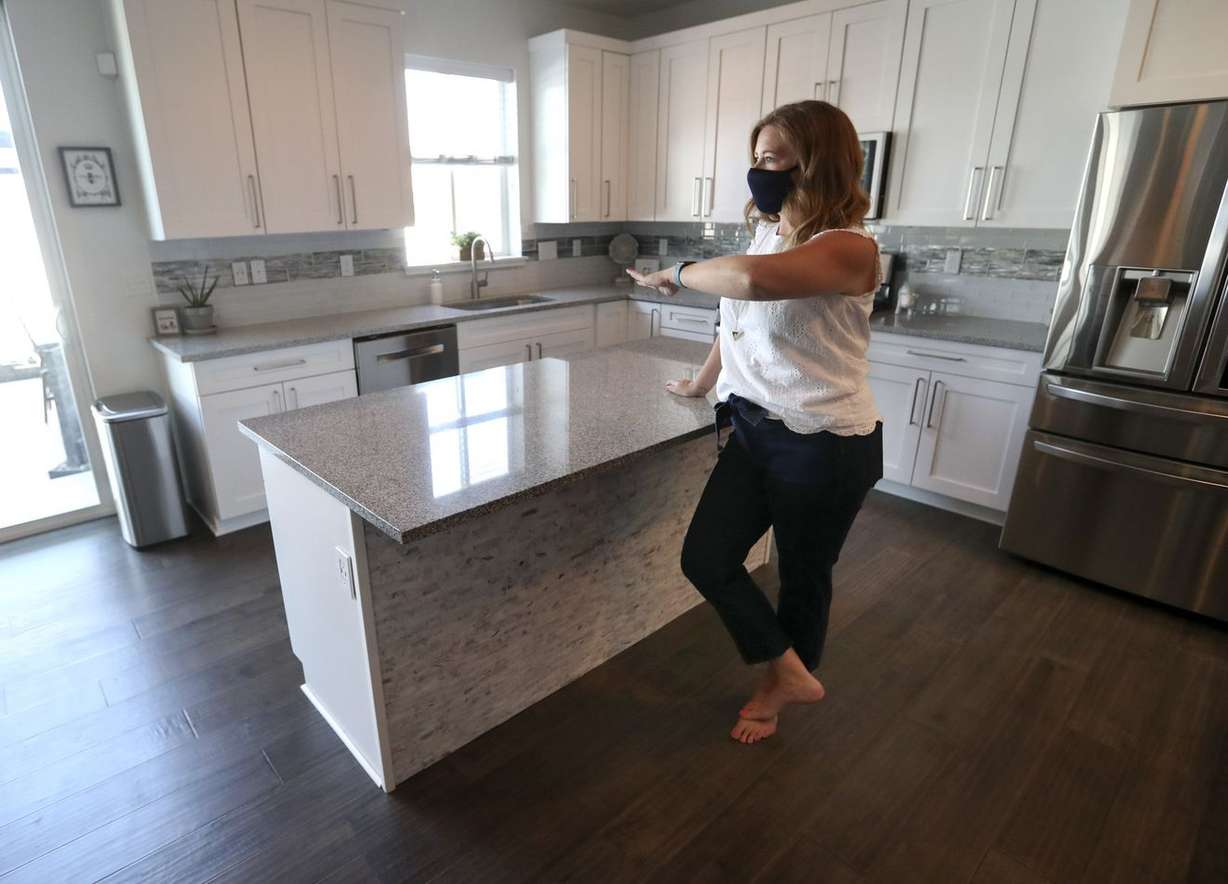 Real estate agent Alicia Holdaway, with Summit Sotheby’s International Realty and president of the Salt Lake Board of Realtors, walks through a home for sale in Bluffdale on Monday, July 20, 2020.