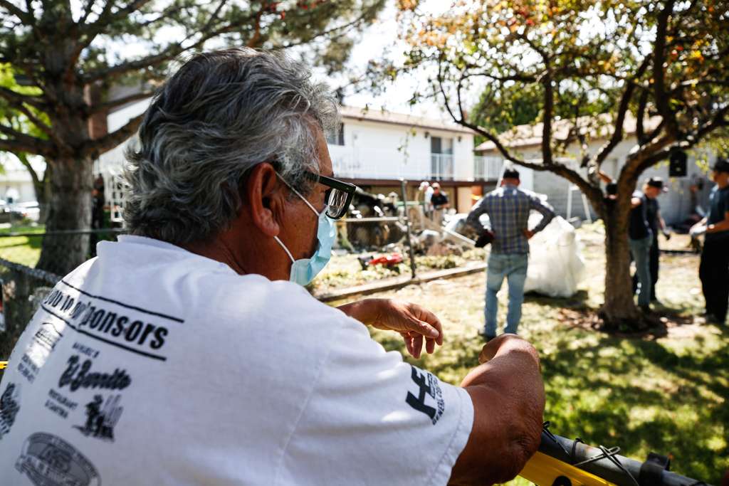 Joe Murillo looks as crews clear debris on Sunday, July 26, 2020, that remains from a plane crash that severely injured his sister and damaged her West Jordan home. Three people died in the crash Saturday afternoon.