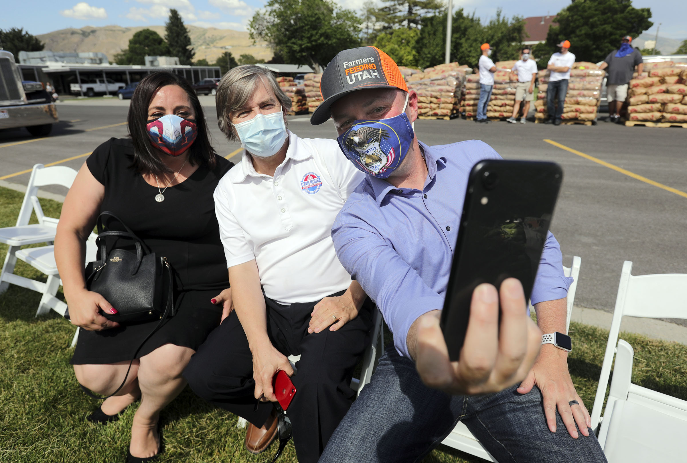 Lt. Gov. Spencer Cox, right, takes a selfie with Rep. Angela Romero, D-Salt Lake City, and Rep. Joel Briscoe, D-Salt Lake City, after a press conference about Farmers Feeding Utah donating food to those in need at the Utah State Fairpark in Salt Lake City on Monday, July 27, 2020.