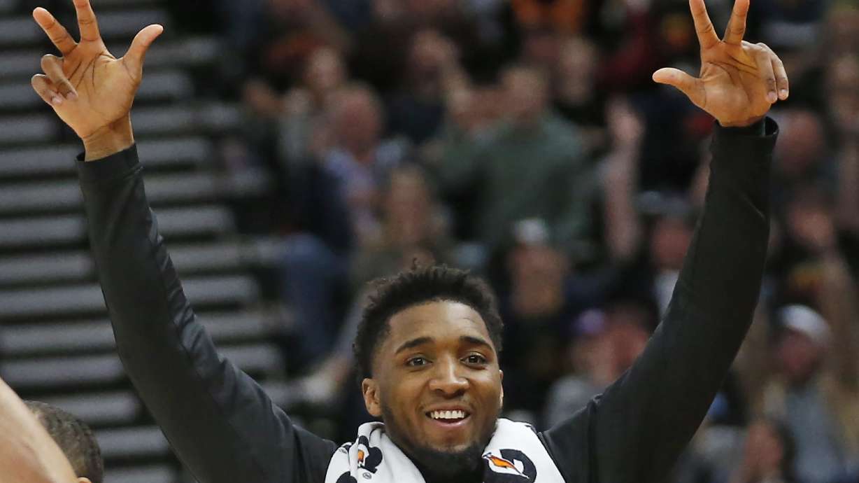 Utah Jazz guard Donovan Mitchell celebrates after teammate Jordan Clarkson scores against the Miami Heat in the second half during an NBA basketball game Wednesday, Feb. 12, 2020, in Salt Lake City.