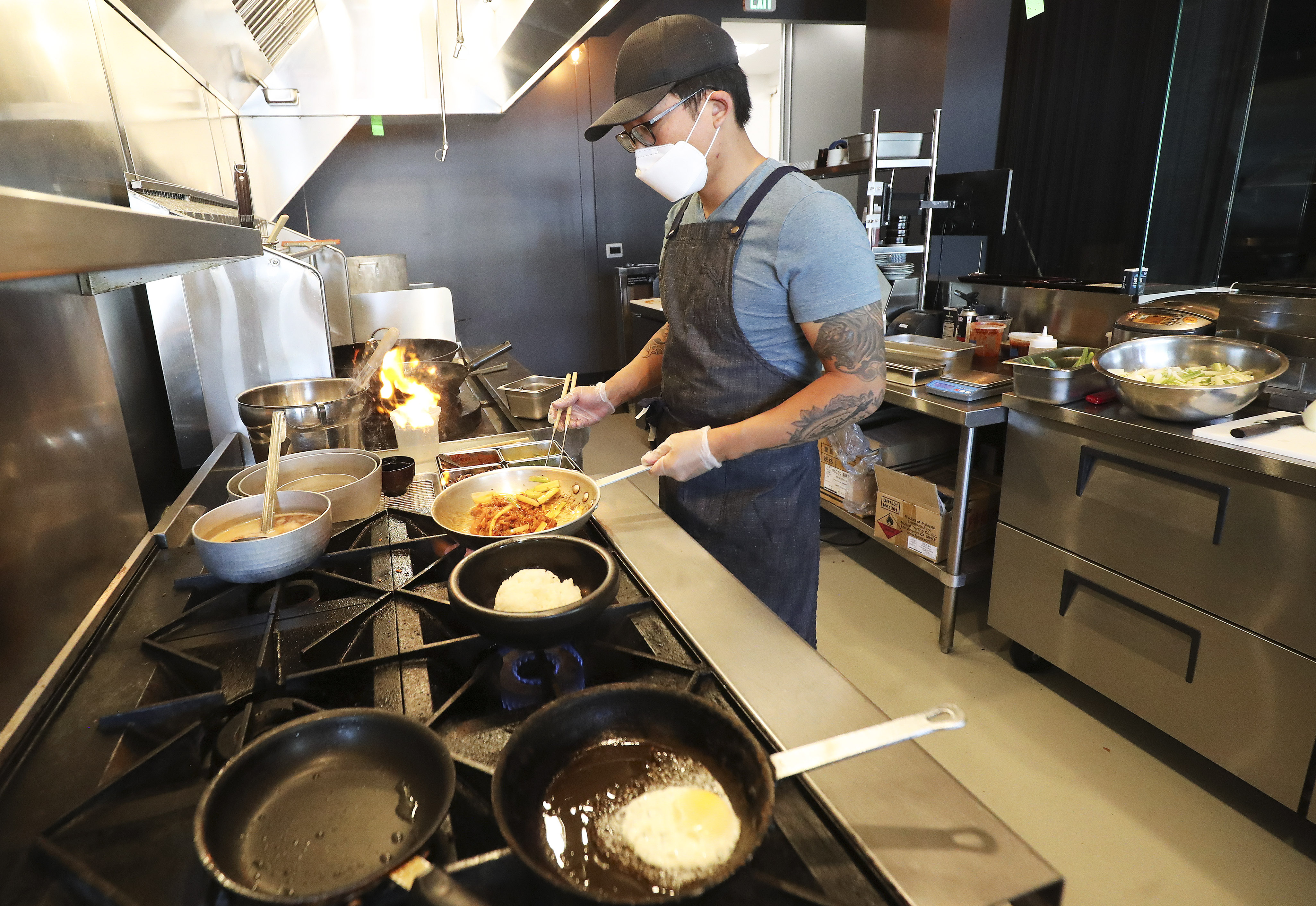 Nohm owner and chef David Chon prepares a meal for customers at the restaurant in Salt Lake City on Tuesday, July 28, 2020. Salt Lake County Mayor Jenny Wilson announced an expansion of the Small Business Impact Grant program to a variety of businesses hurt by COVID-19.