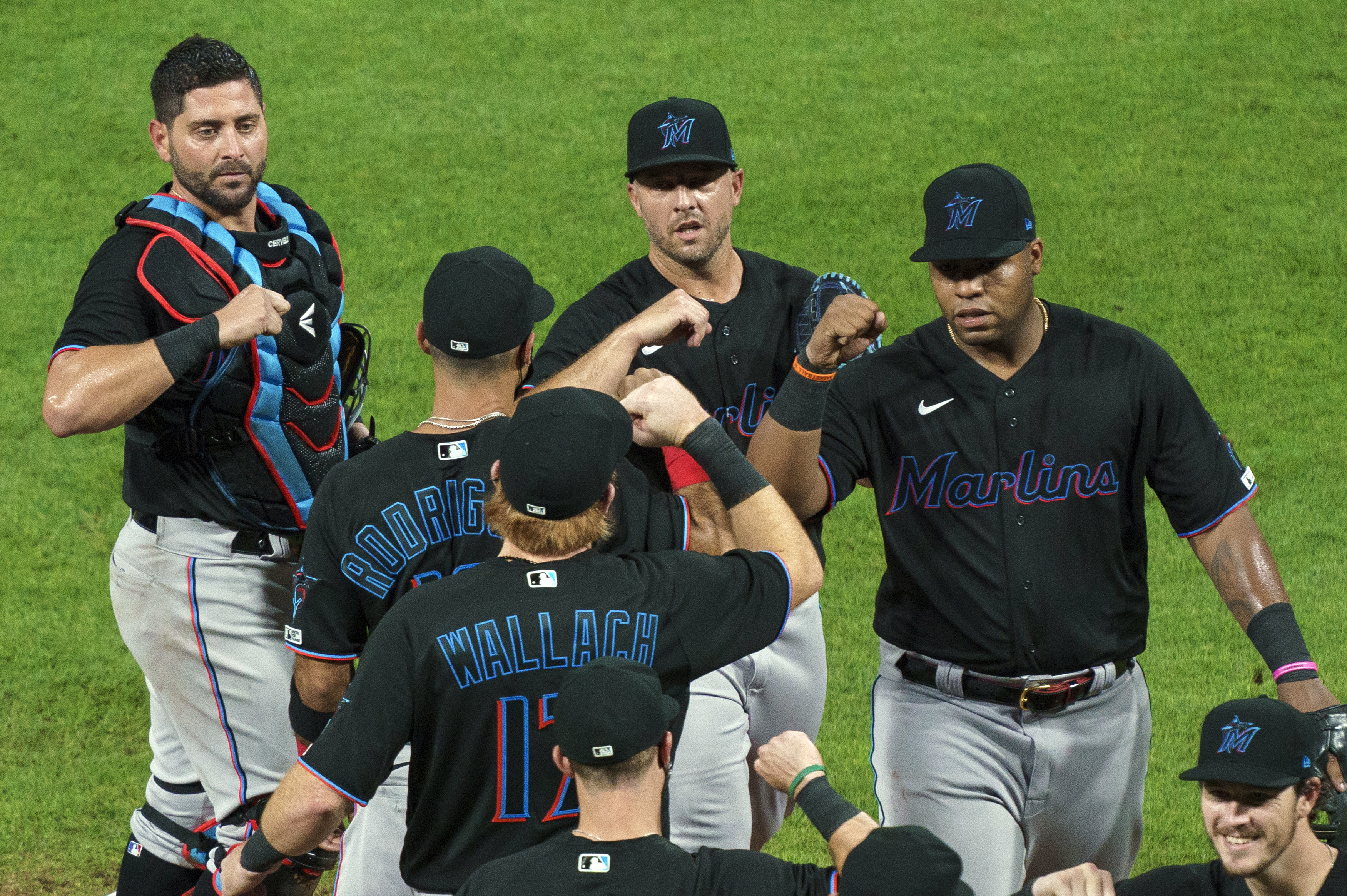 In this Friday, July 24, 2020, file photo, Miami Marlins' Jesus Aguilar, right, celebrates a 5-2 win with teammates following a baseball game against the Philadelphia Phillies in Philadelphia. The Marlins’ coronavirus outbreak could endanger the Major League Baseball season, Dr. Anthony Fauci said, as the number of their players testing positive rose to 15. The Marlins received positive test results for four additional players Tuesday, July 23, 2020, a person familiar with the situation told The Associated Press.