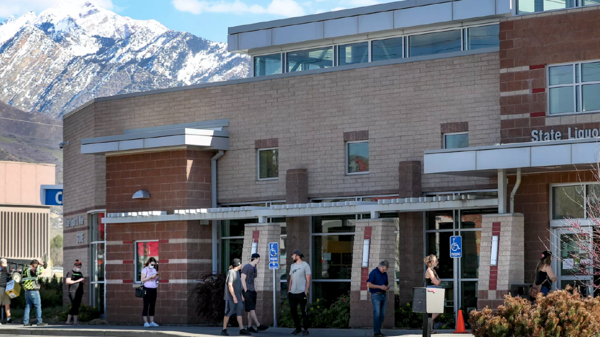 People practice social distancing as they wait in line to shop at the Utah State Liquor Store at 1814 E. Murray Holladay Road in Holladay on Tuesday, April 21, 2020.