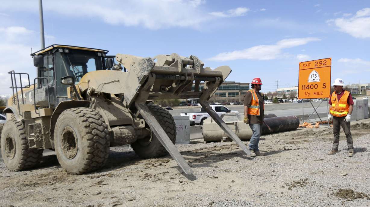 Construction crews work on a new I-15 northbound travel lane, which runs from Bangerter Highway to 9400 South, in Draper on Thursday, April 9, 2020.