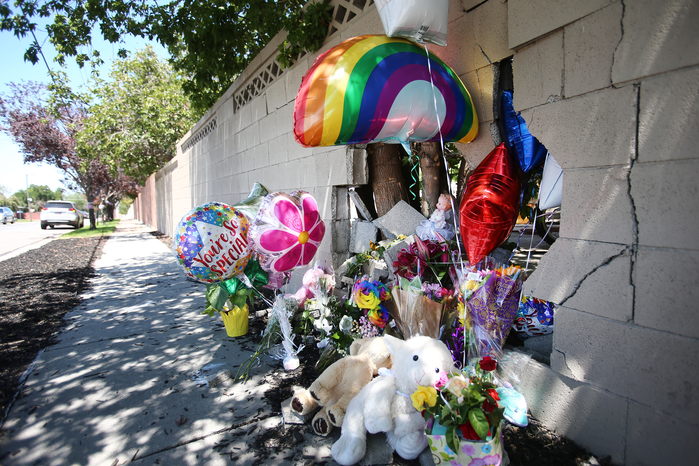 A small memorial has been placed at the scene of an accident in Taylorsville on Wednesday, July 29, 2020. An auto-pedestrian crash occurred Tuesday when a car stopped for a dog and was struck in the rear and pushed into a mother pushing a stroller, killing a 2-year-old girl.