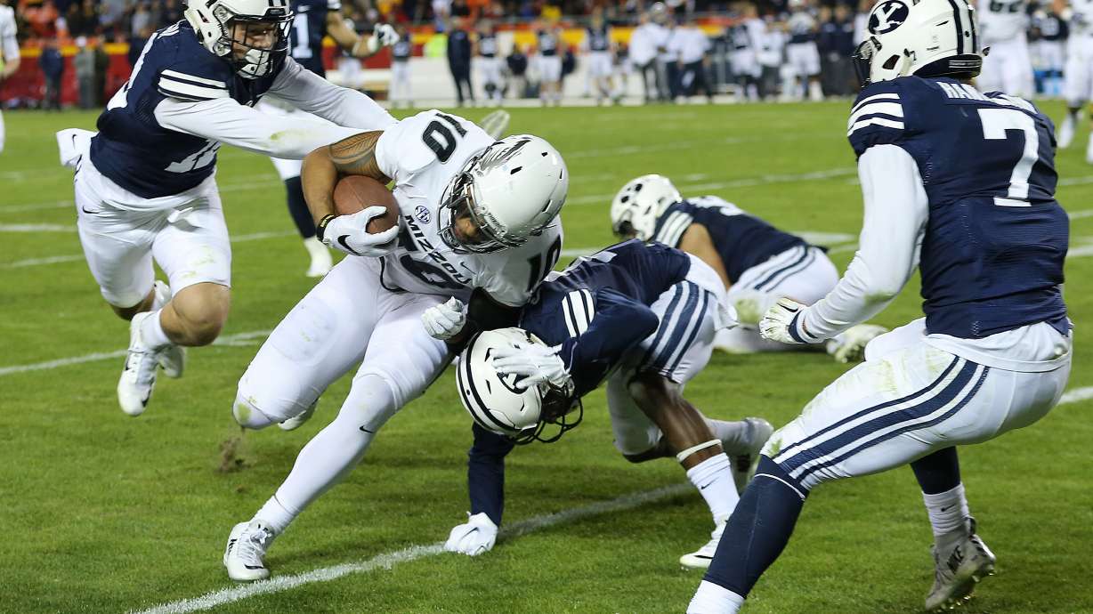 Missouri Tigers tight end Jason Reese (10) is driven out of bounds by Cougar defenders as BYU and Missouri play at Arrowhead Stadium in Kansas City, Missouri, Saturday, Nov. 14, 2015. Missouri won 20-16.