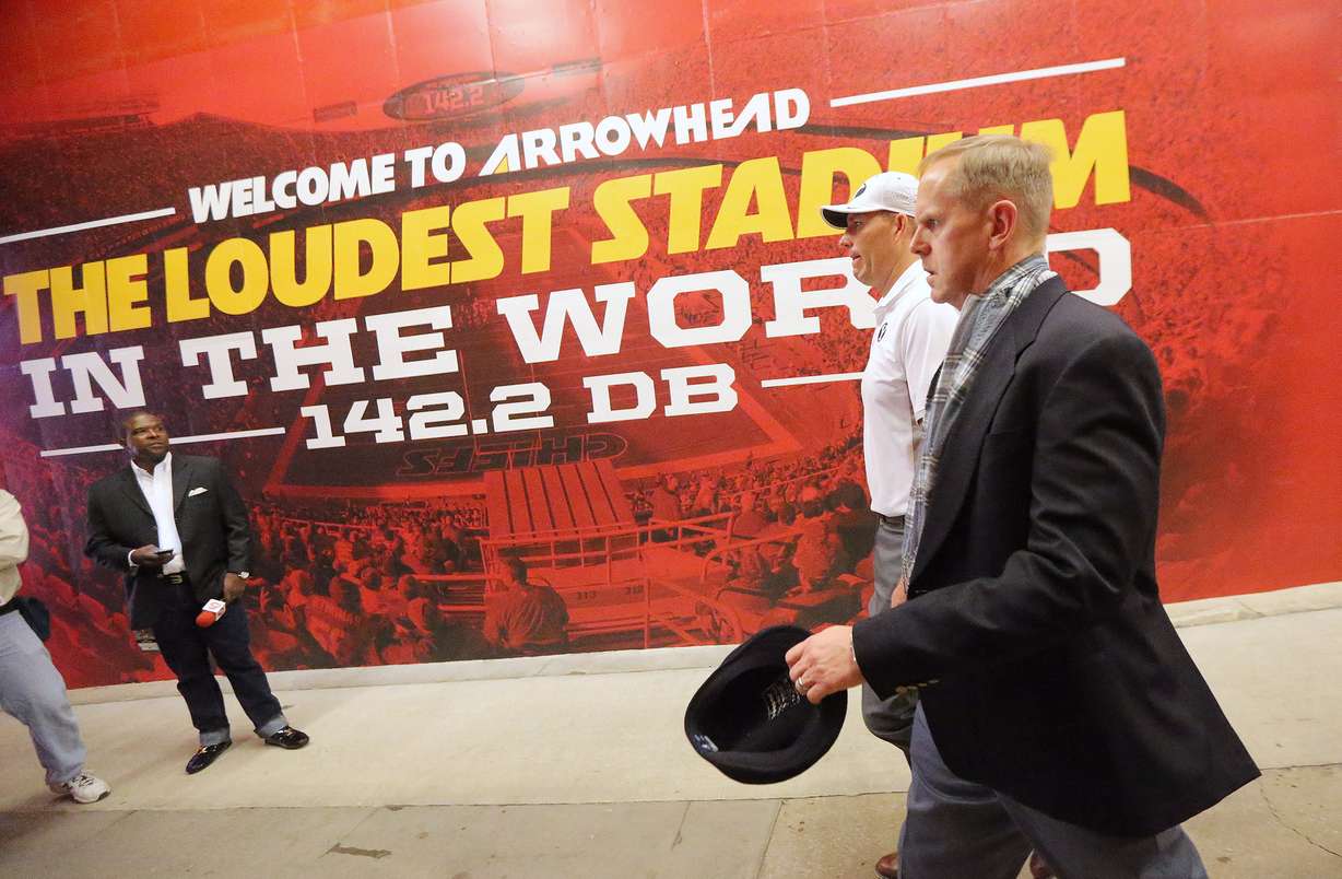 BYU Director of Athletics Tom Holmoe, right, walks into Arrowhead Stadium prior to a game with Missouri in Kansas City Missouri Saturday, Nov. 14, 2015.