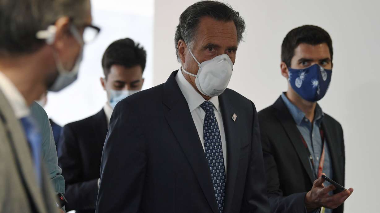 Sen. Mitt Romney, R-Utah, talks to reporters as he arrives for the weekly Republican policy luncheon on Capitol Hill in Washington, Tuesday, June 9, 2020.