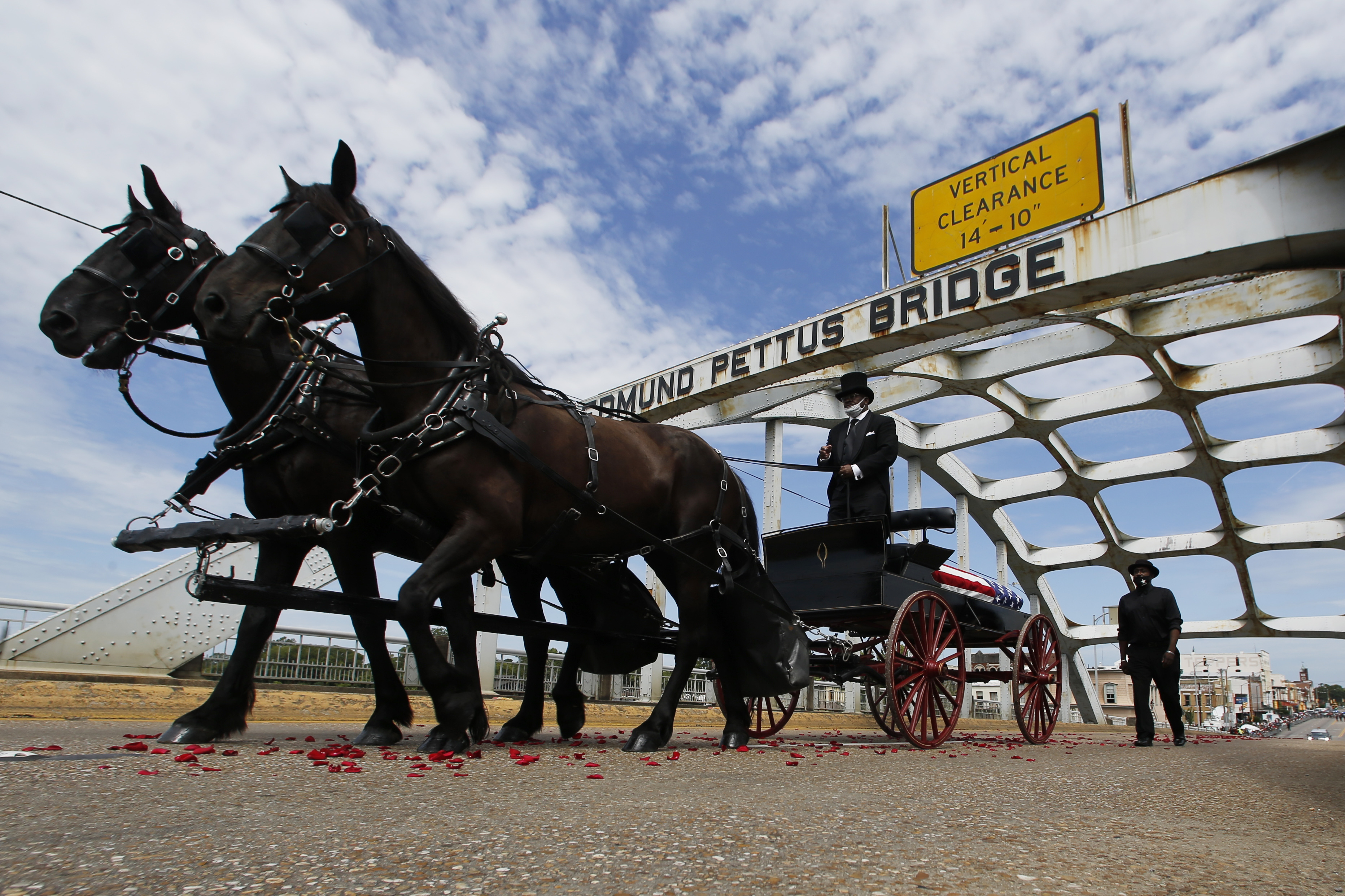 The casket of Rep. John Lewis moves over the Edmund Pettus Bridge by horse drawn carriage during a memorial service for Lewis, Sunday, July 26, 2020, in Selma, Ala. Lewis, who carried the struggle against racial discrimination from Southern battlegrounds of the 1960s to the halls of Congress, died Friday, July 17, 2020.