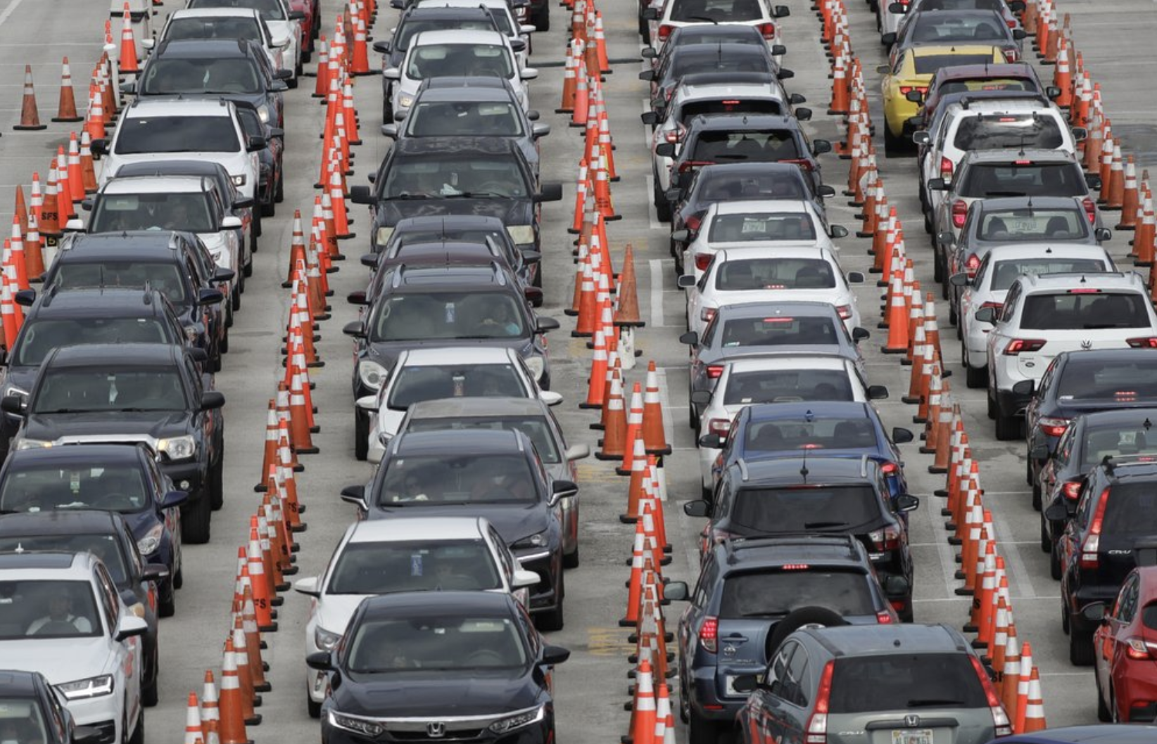 FILE - In this July 5, 2020, file photo, lines of cars wait at a drive-thru coronavirus testing site outside Hard Rock Stadium in Miami Gardens, Fla. As coronavirus cases surge in hard-hit Florida, so do the turnaround times for test results. 