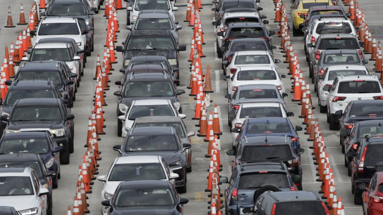 FILE - In this July 5, 2020, file photo, lines of cars wait at a drive-thru coronavirus testing site outside Hard Rock Stadium in Miami Gardens, Fla. As coronavirus cases surge in hard-hit Florida, so do the turnaround times for test results.